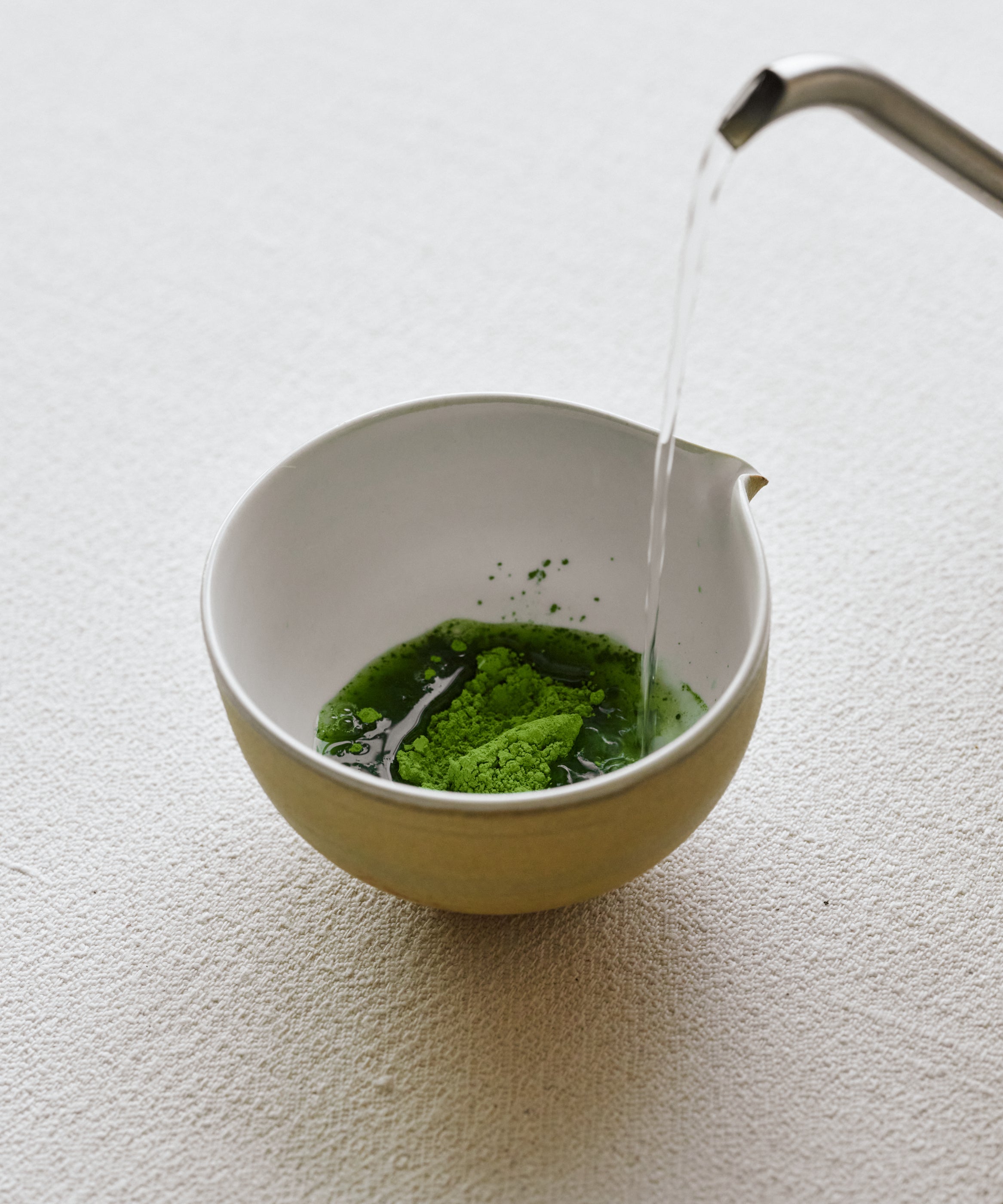 Scooping Matcha Kakegawa Japanese matcha powder into white bowl