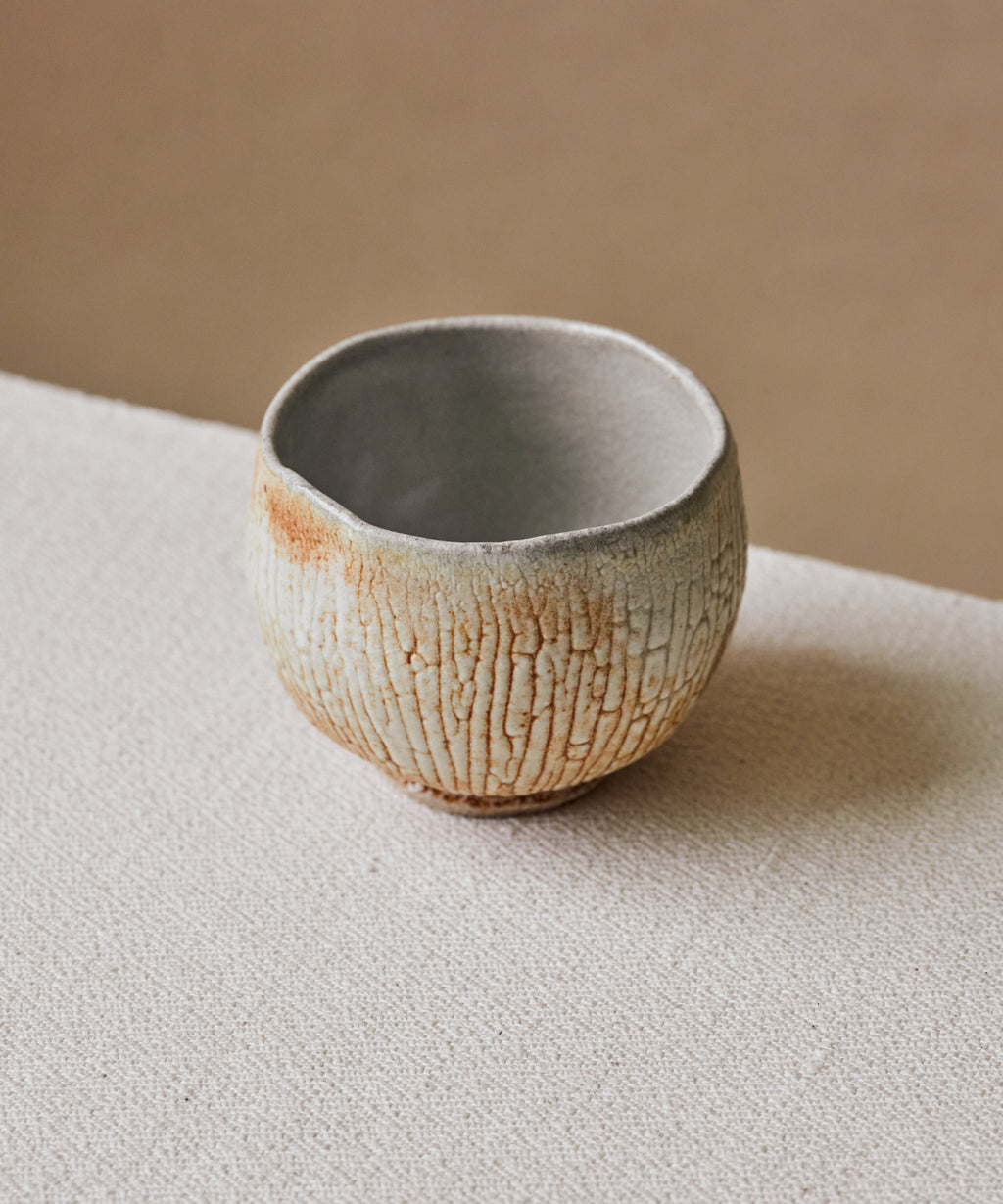 Chawan No. 71 in hand, stoneware chawan with shino glaze