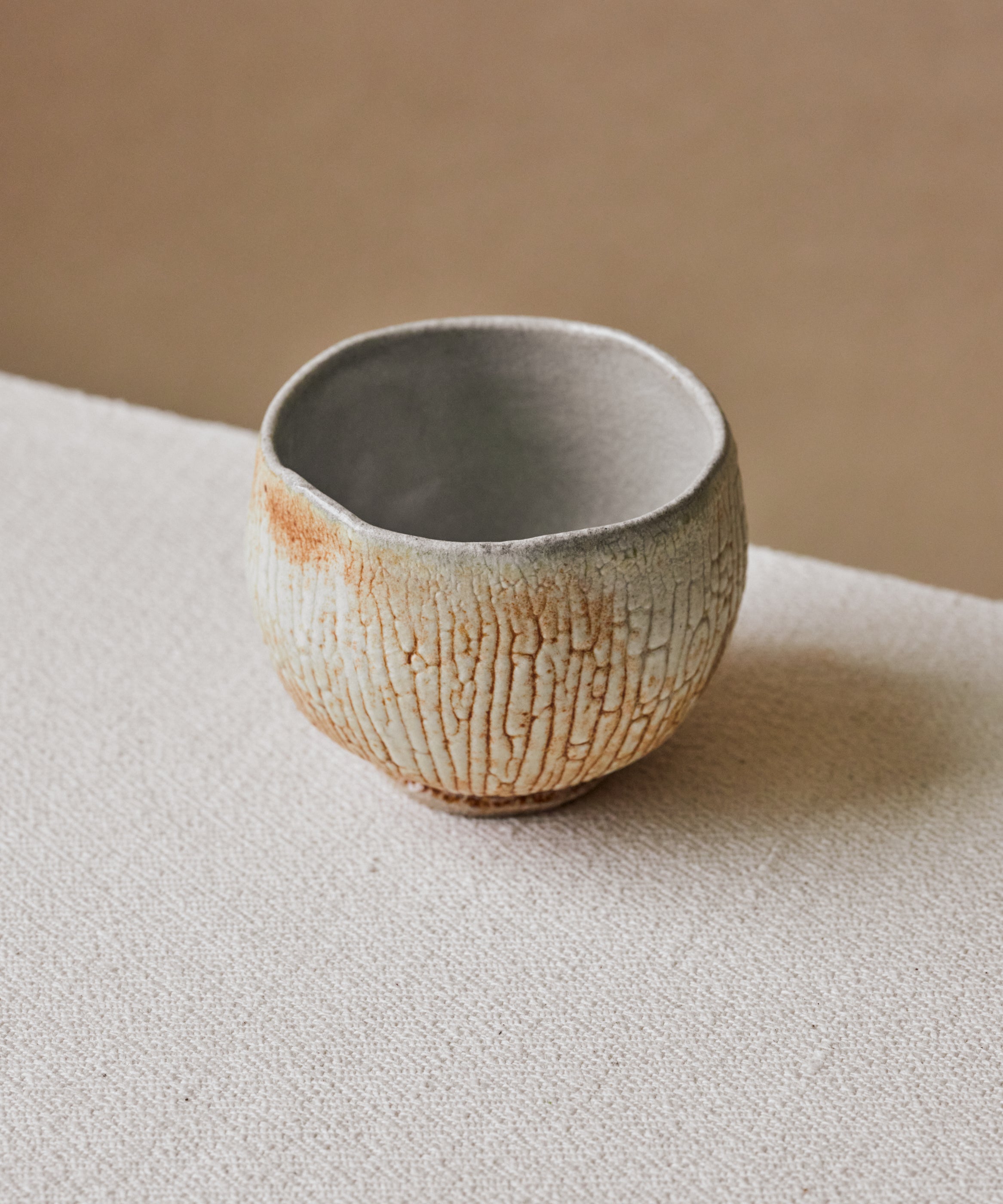 Chawan No. 71 in hand, stoneware chawan with shino glaze