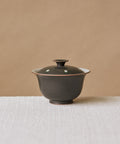 Gaiwan Black Peacock, handcrafted gaiwan by Wang Xinghua, Jingdezhen, matte black glaze with green-ringed white spots
