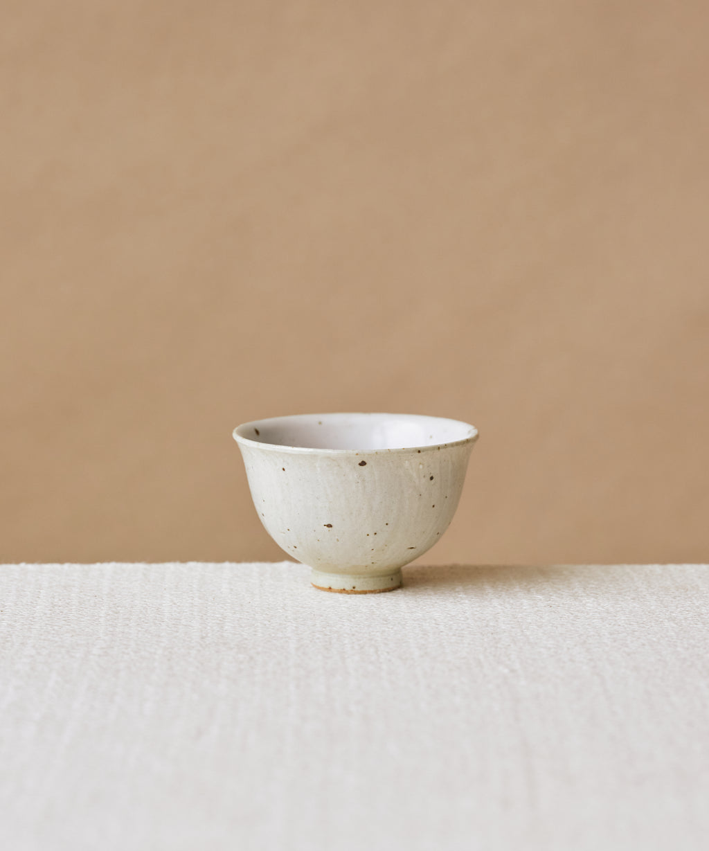 Rock Cup, handcrafted tea cup by Wang Xinghua, Jingdezhen, matte cement surface with copper kiln spots