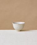Rock Cup, handcrafted tea cup by Wang Xinghua, Jingdezhen, matte cement surface with copper kiln spots