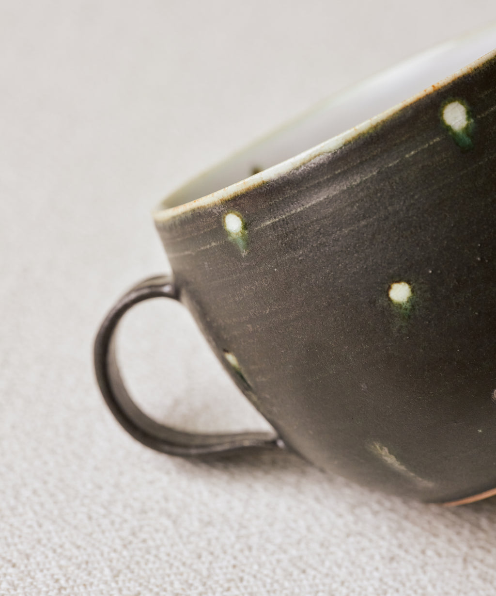 Black Peacock Mug glaze detail, peacock feather teardrops on midnight surface, Jingdezhen clay and porcelain