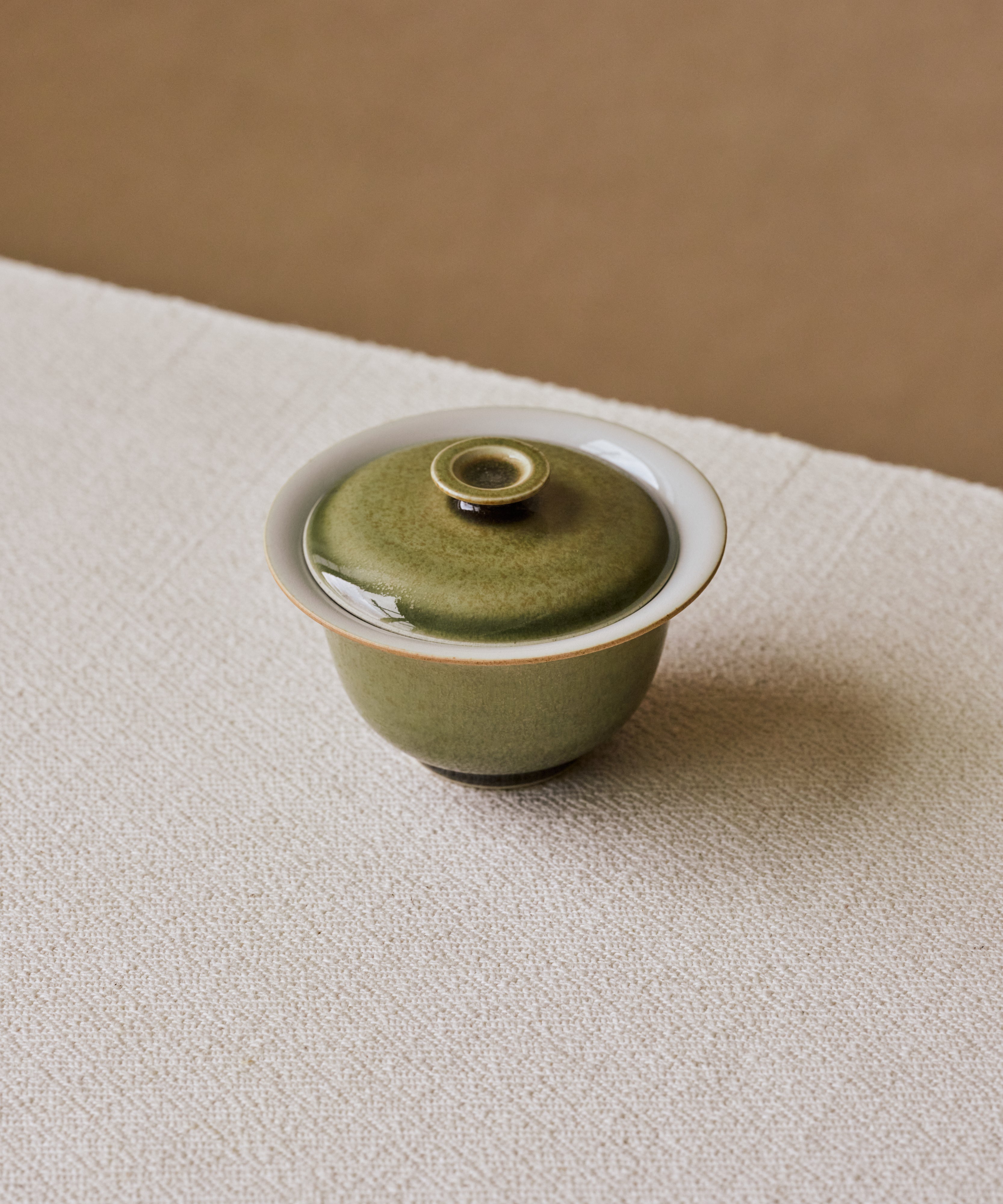 Ombre Green Gaiwan Vol 2 in hand, ombre green glaze with bronze flakes, Wang Xinghua gongfu teaware