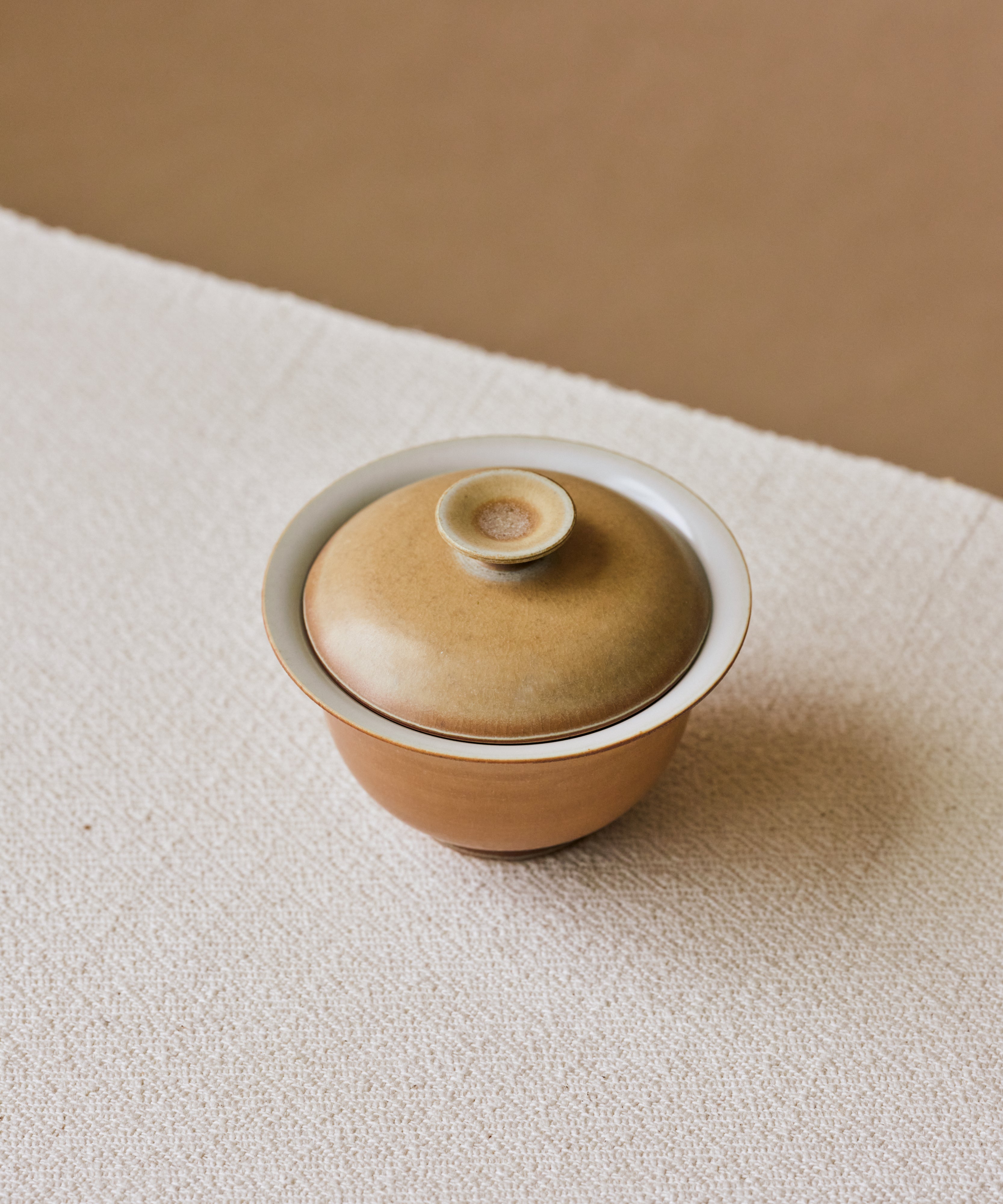 Clamshell V1 Gaiwan in hand, shell-like glaze with calcification rings, Wang Xinghua gongfu teaware