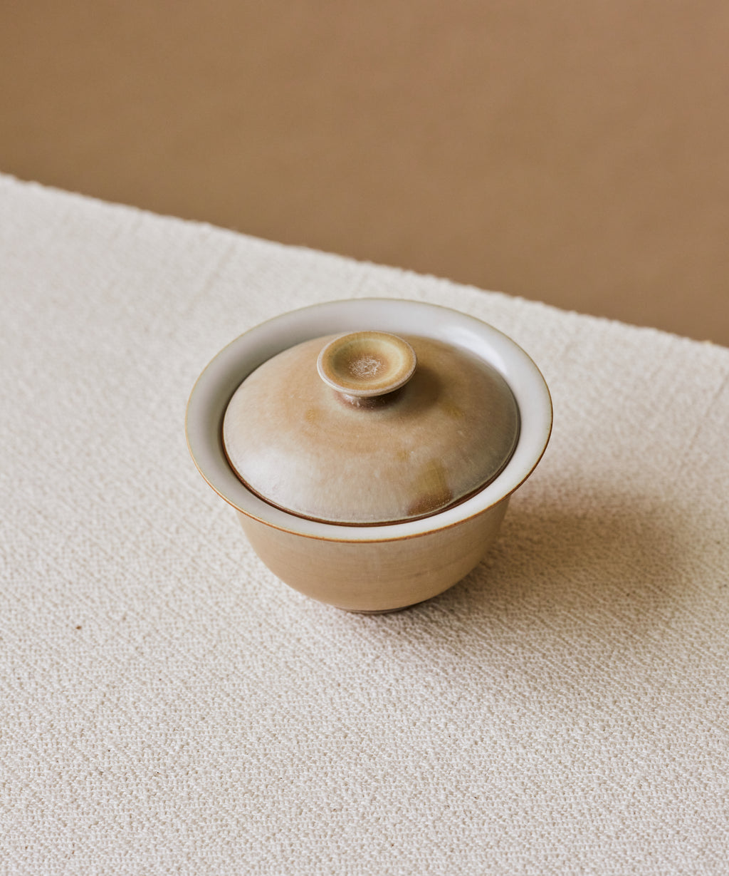 Clamshell V2 Gaiwan in hand, calcification rings on shell-like surface, Wang Xinghua gongfu teaware