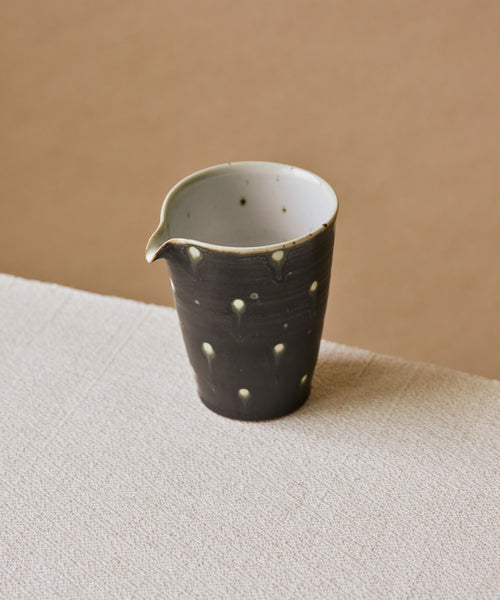 Black Peacock Pitcher Type II in hand, curved spout for precise pours, Wang Xinghua gongfu teaware