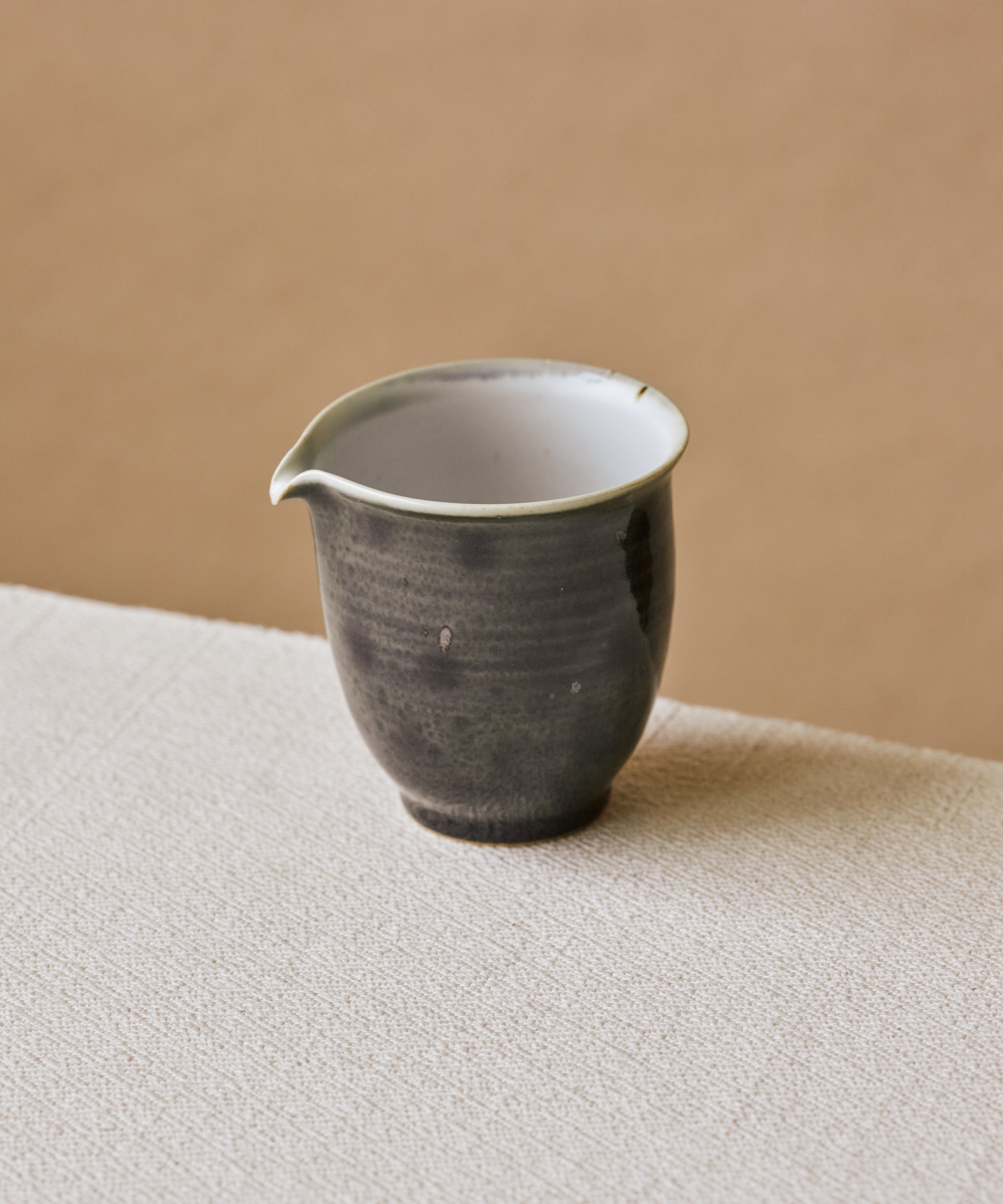 Ombre Blue Pitcher in hand, deep blue glaze running and bleeding across the surface, Wang Xinghua gongfu teaware
