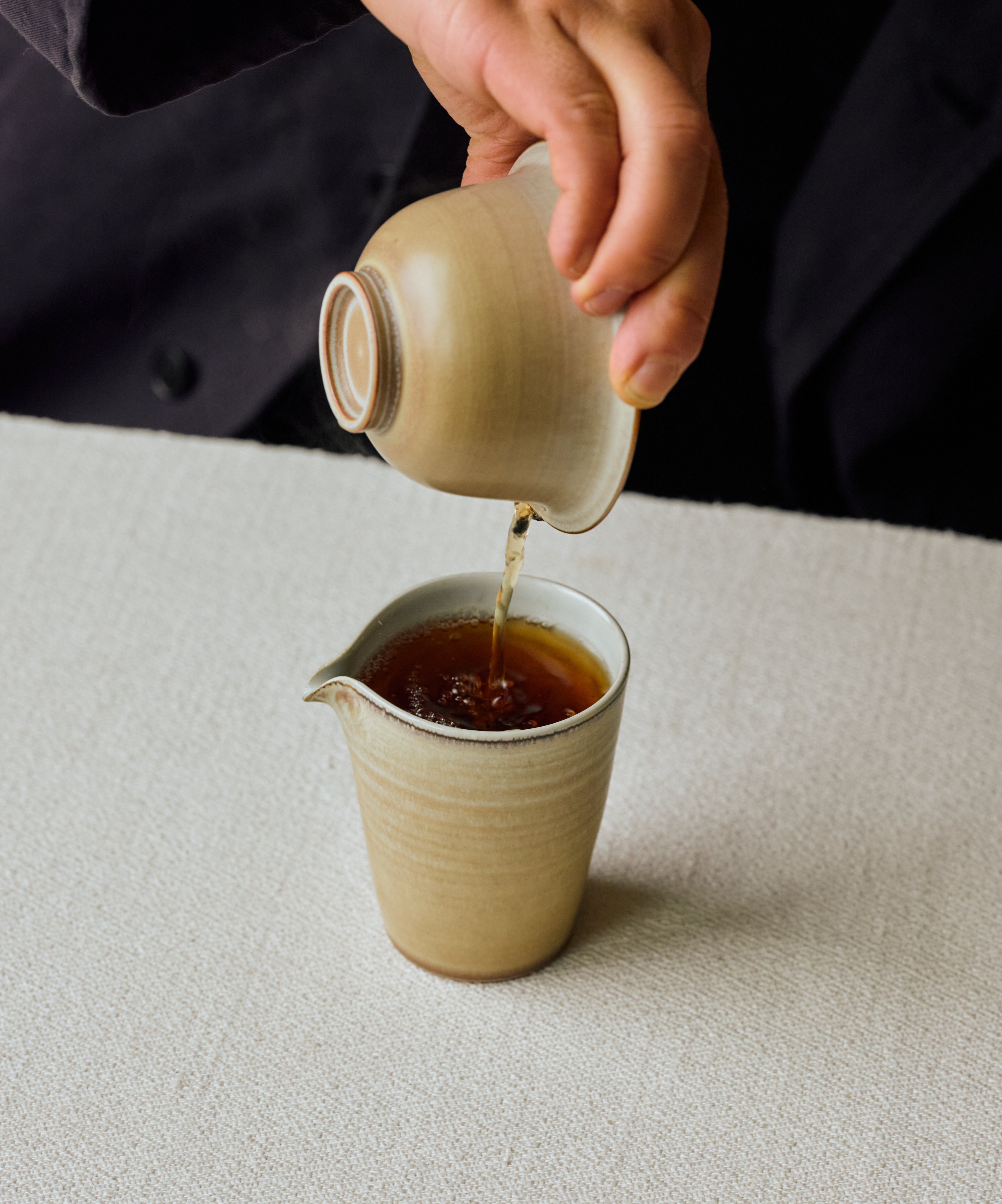 Brewed Charcoal Roasted Tibetan Tea poured into a cup