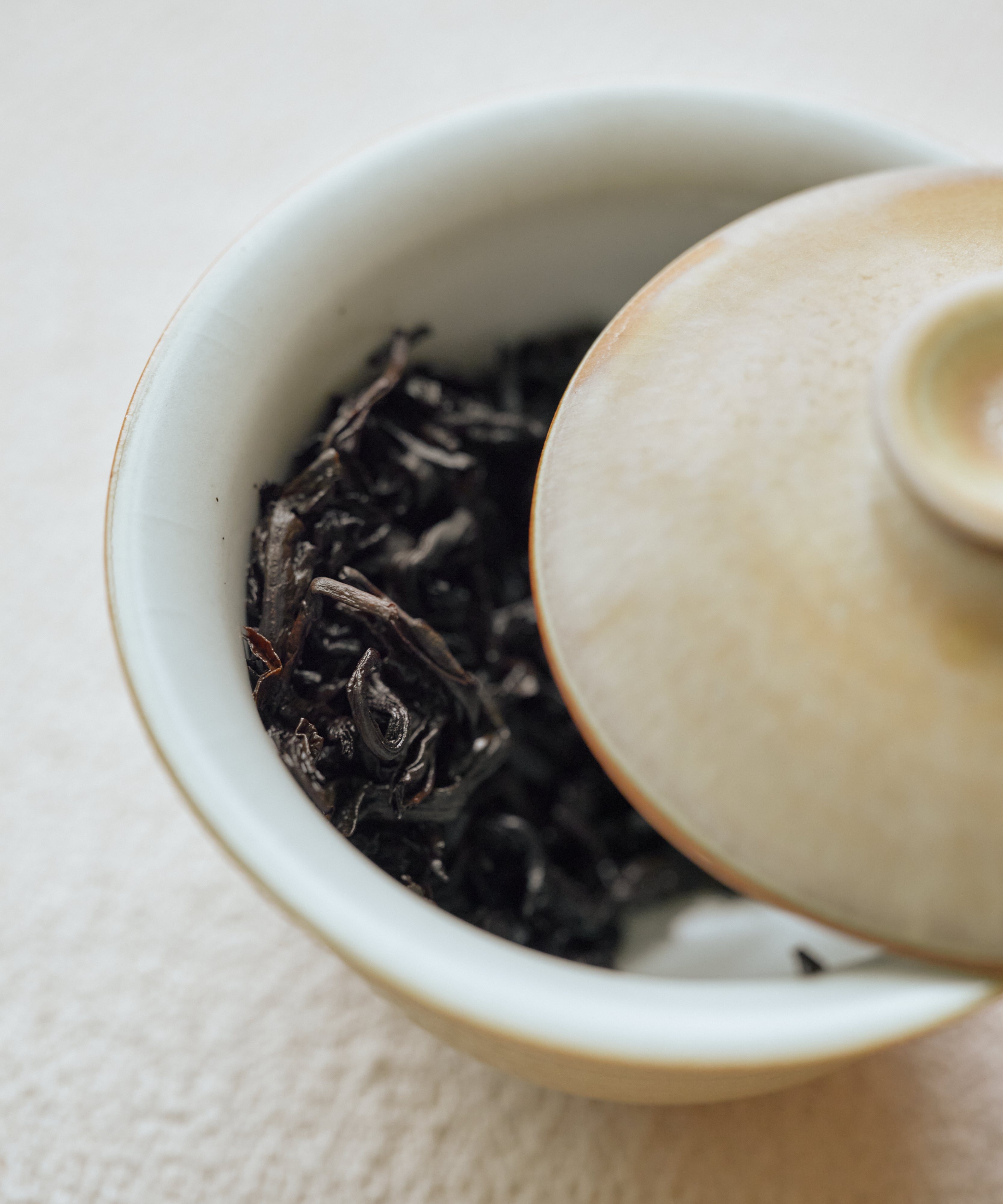 Cup of Charcoal Roasted Tibetan Tea showing bright lean amber liquor with cacao and apricot notes