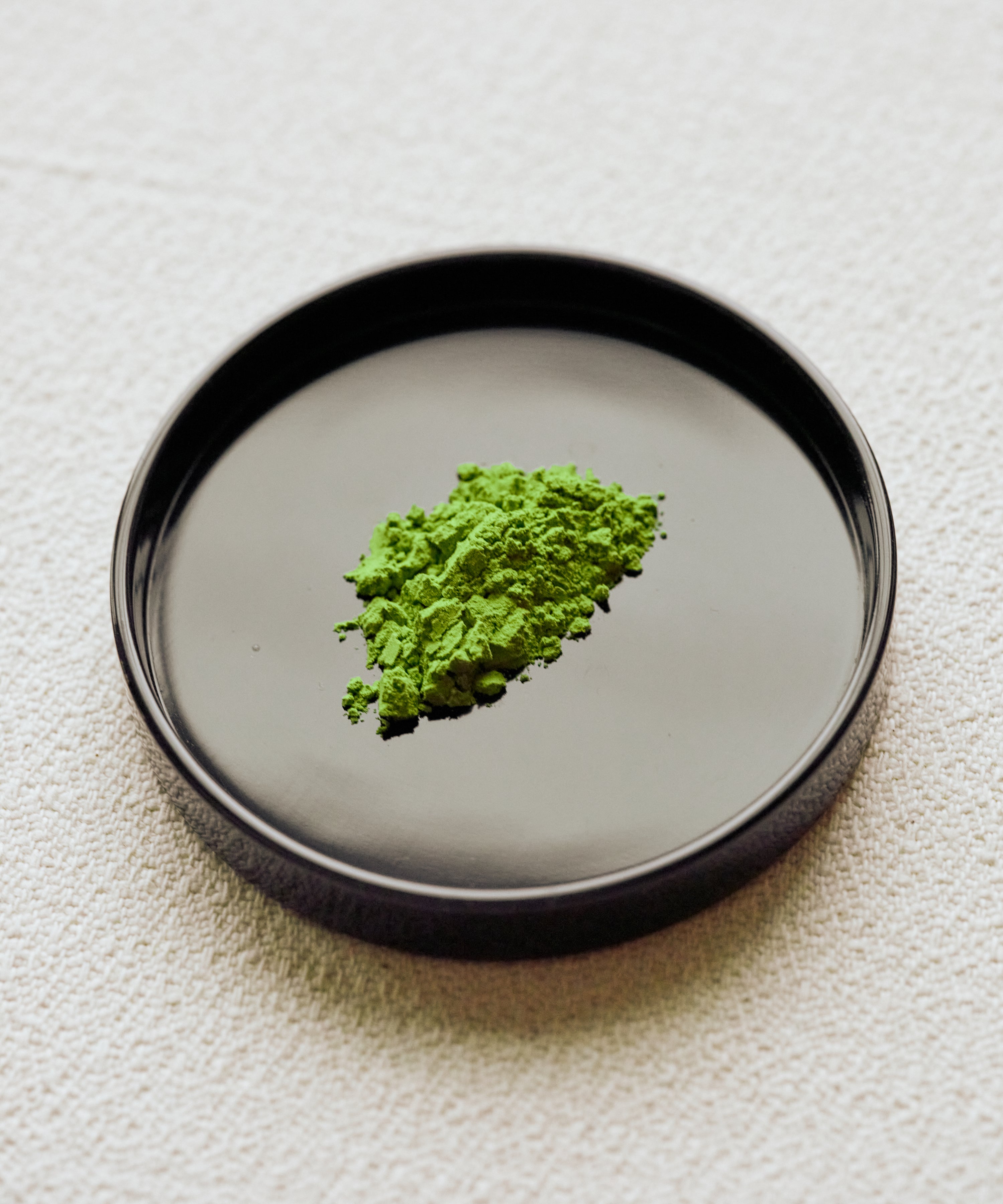 Genmaicha Matcha powder on black plate — ceremonial matcha blended with toasted rice from Shizuoka, Japan