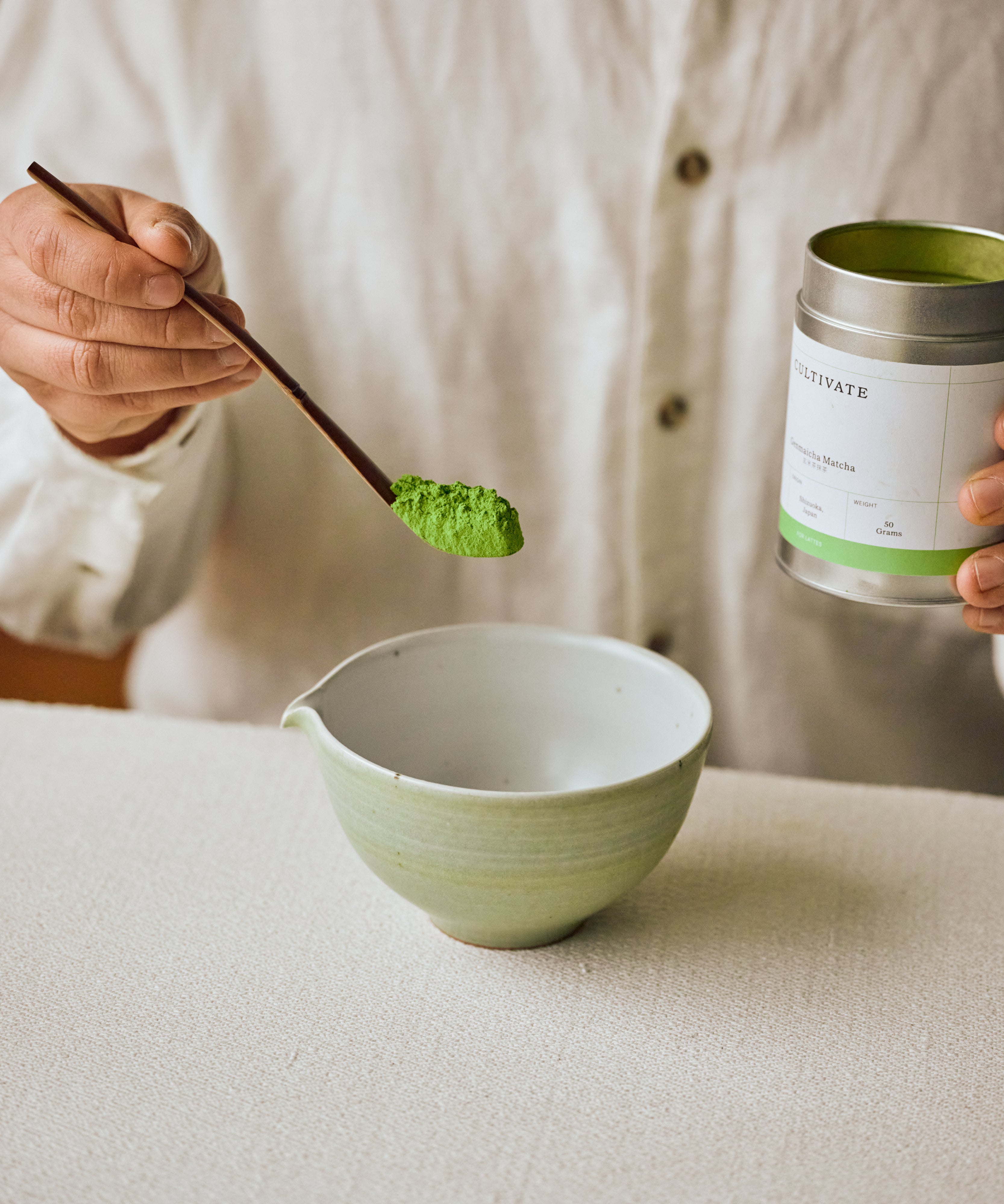 Sifting Genmaicha Matcha into bowl — toasted rice and matcha blend for latte preparation