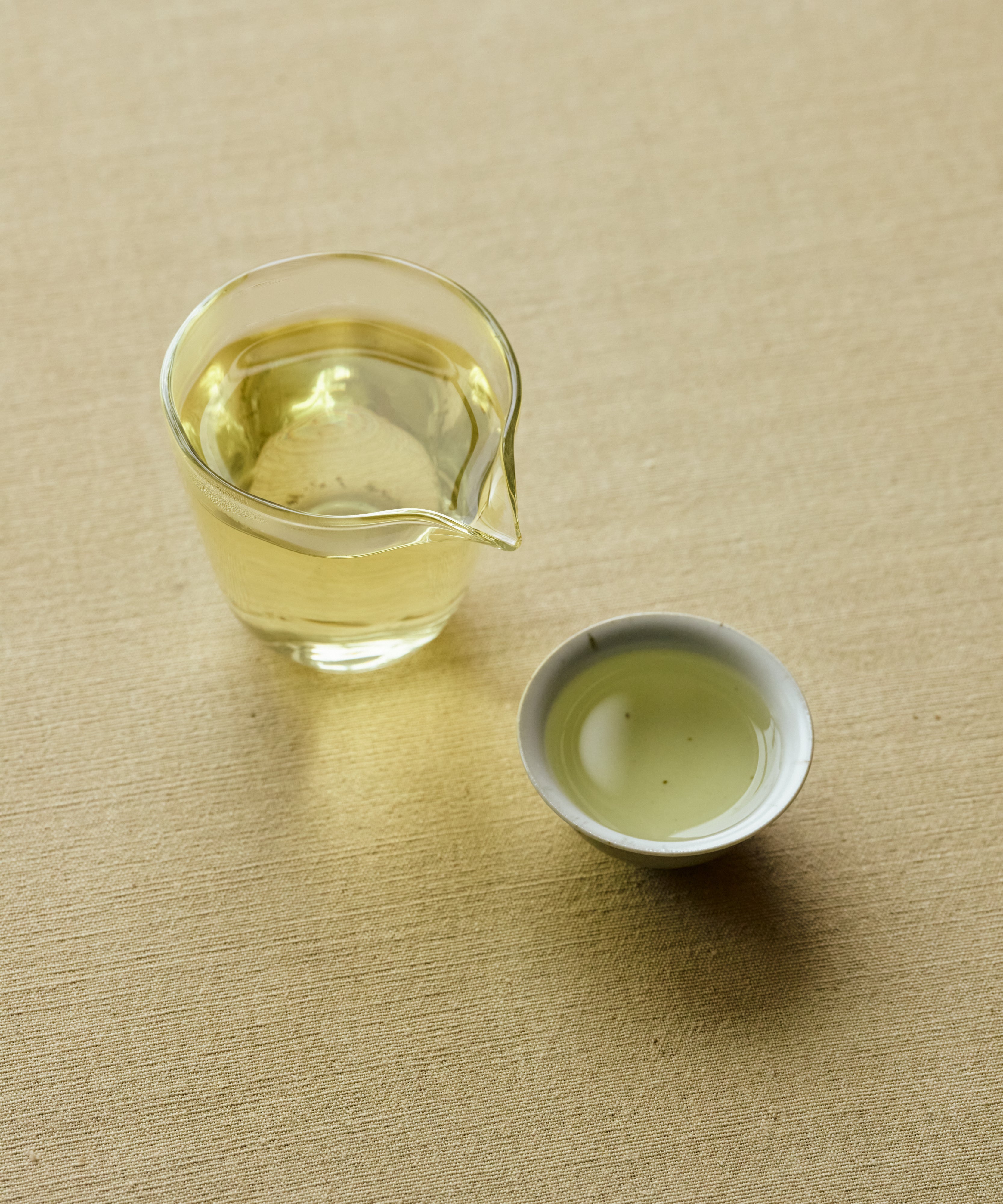 Brewed Jinxuan Milk Oolong poured into a cup showing pale golden liquor