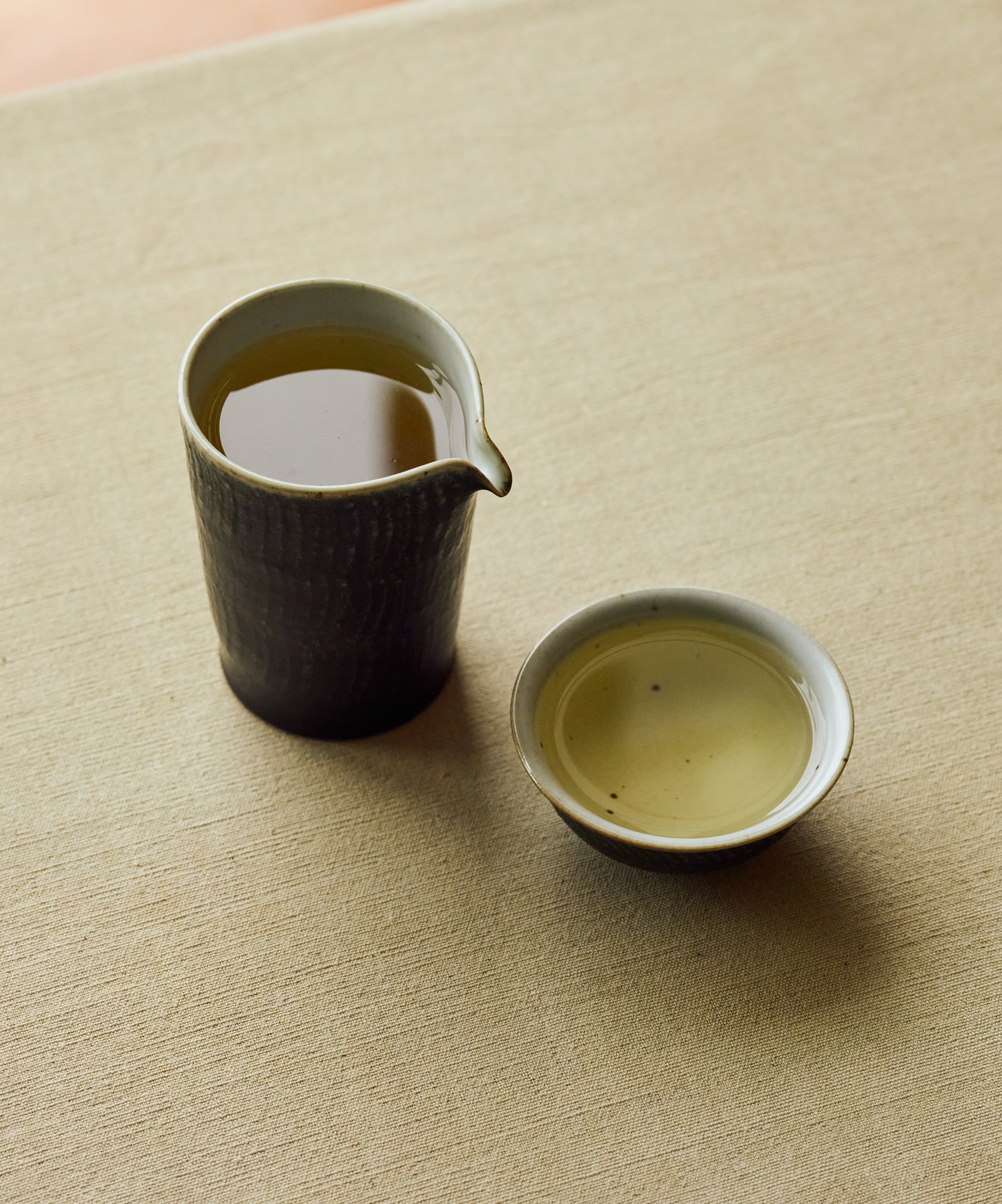 Brewed White Moonlight poured into a cup showing pale golden liquor