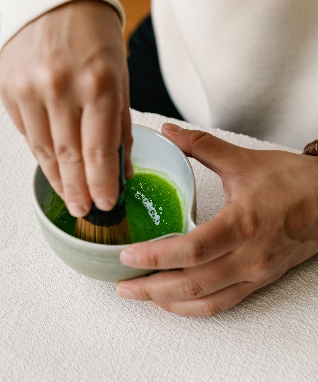 Whisking Matcha Hana Japanese matcha in white chawan
