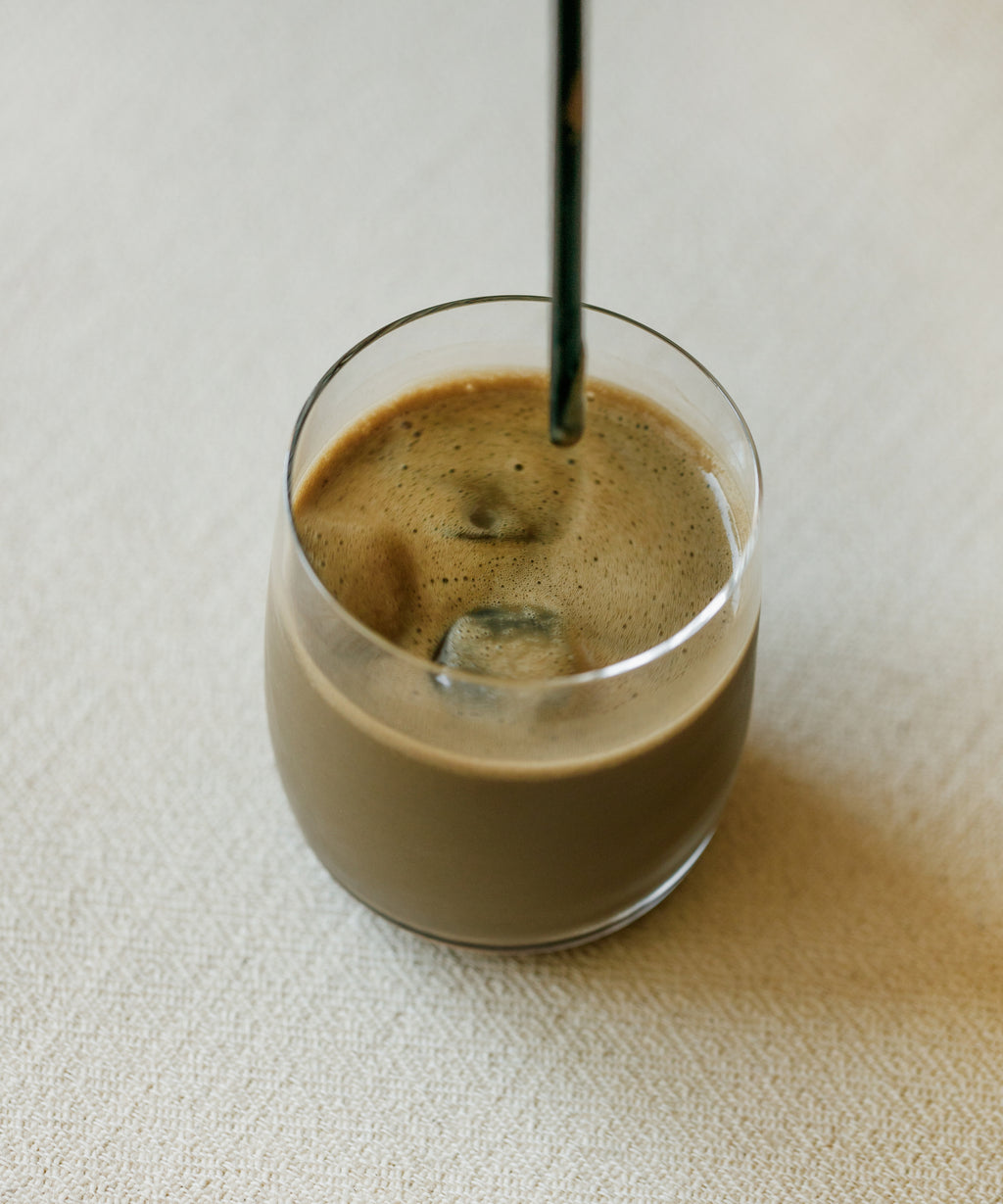 Iced Uji Hojicha latte in glass with oat milk from Cultivate Tea