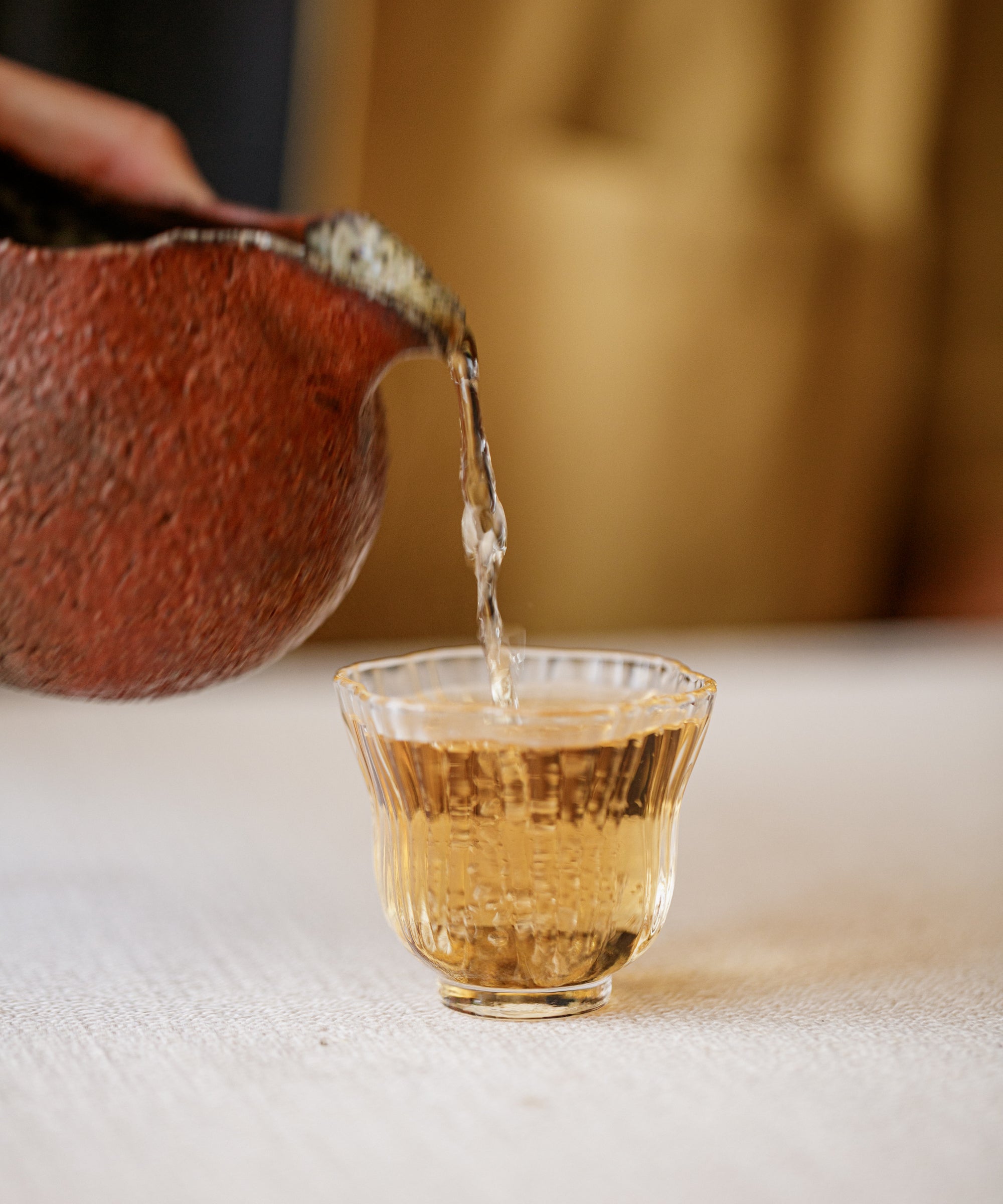 Brewed Lapsang Souchong 2012 poured into a cup showing deep amber liquor