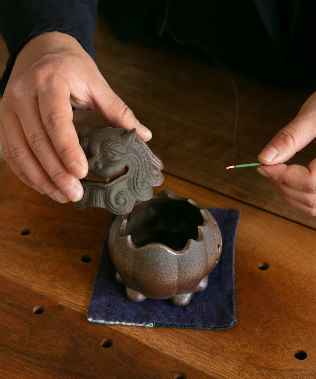 Lion King incense burner in use, smoke trailing from its parted mouth