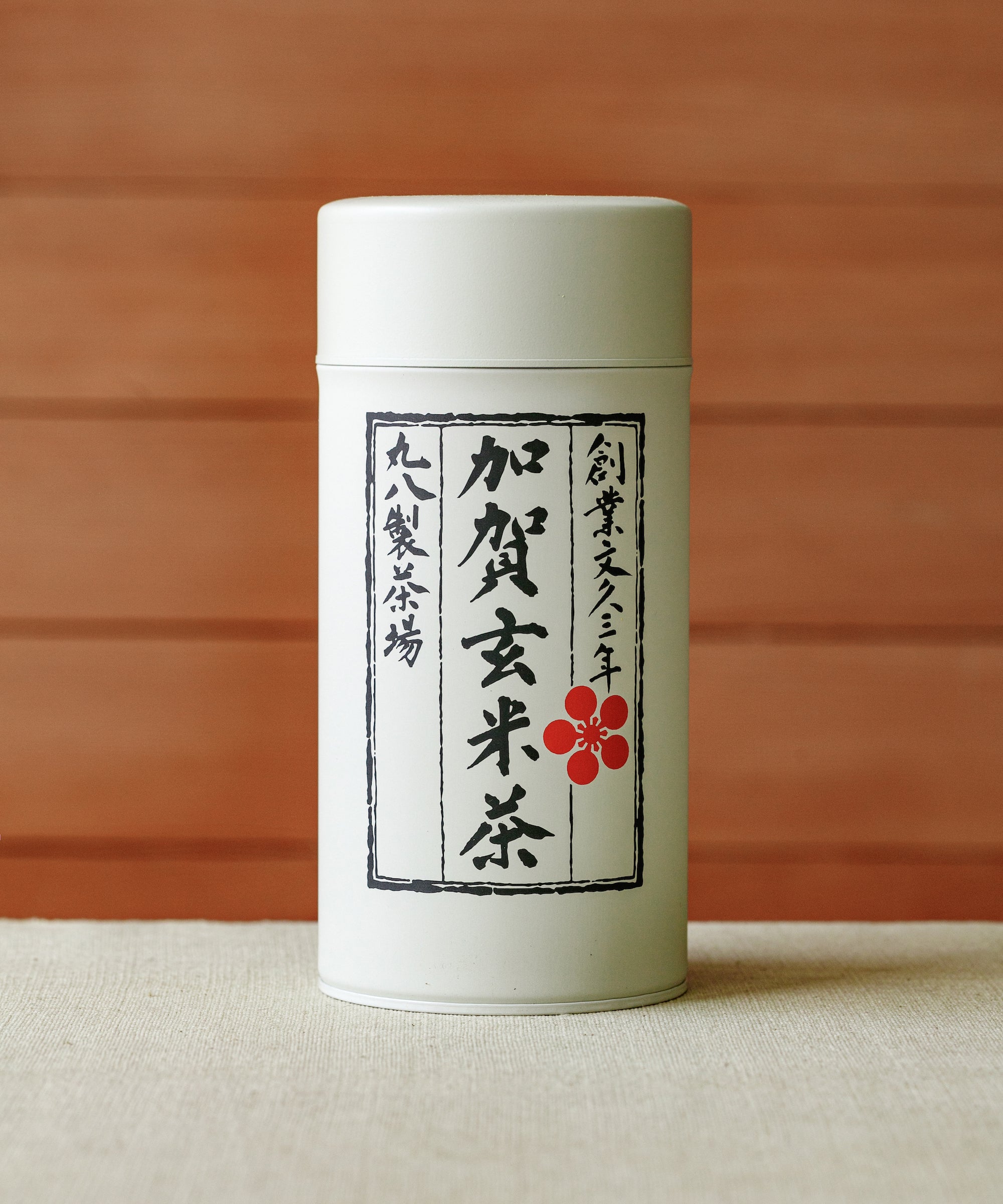 Cup of Kaga Genmaicha showing pale green liquor with briny umami depth