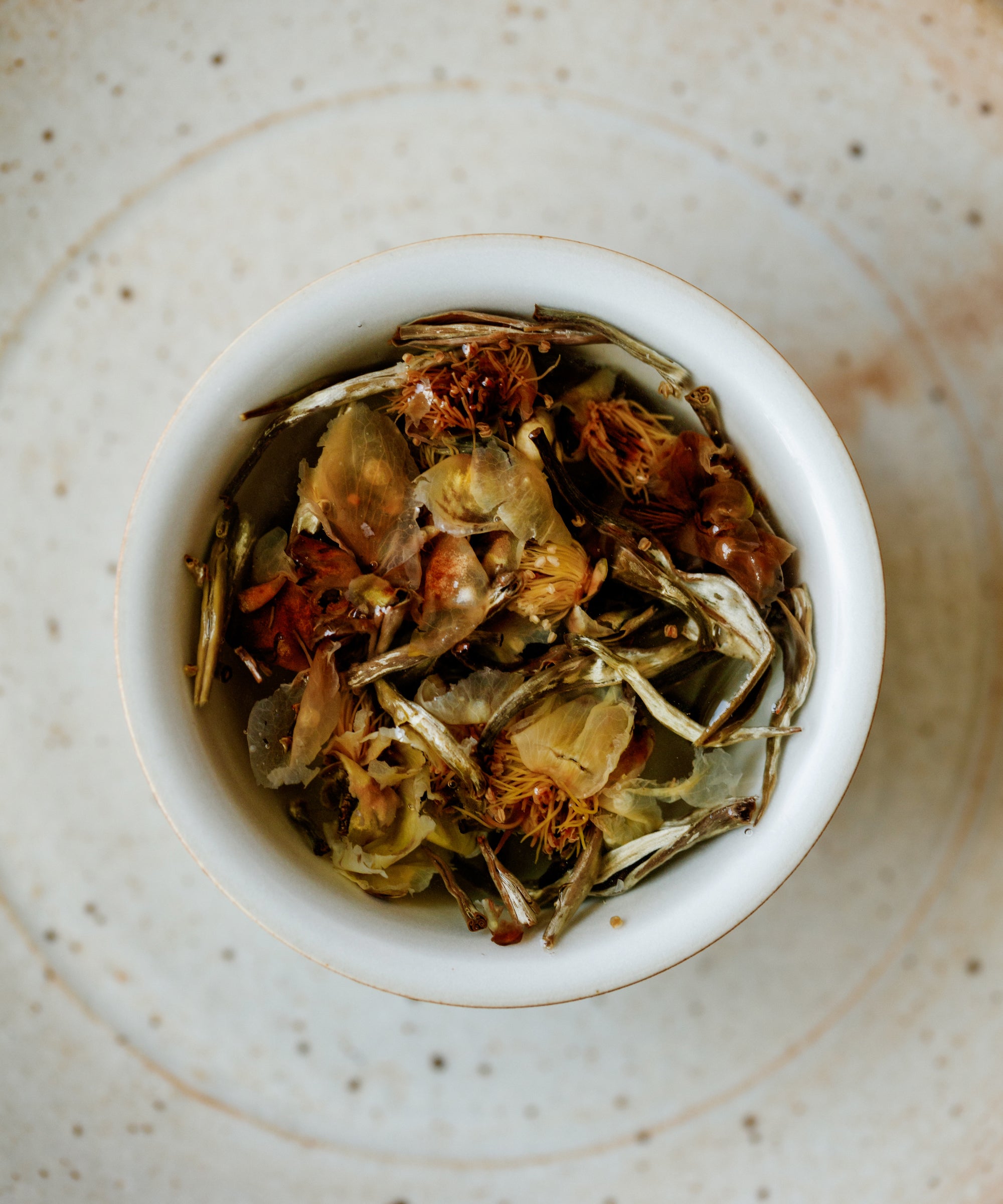 Silver Needle & Tea Blossoms in a vessel ready for brewing