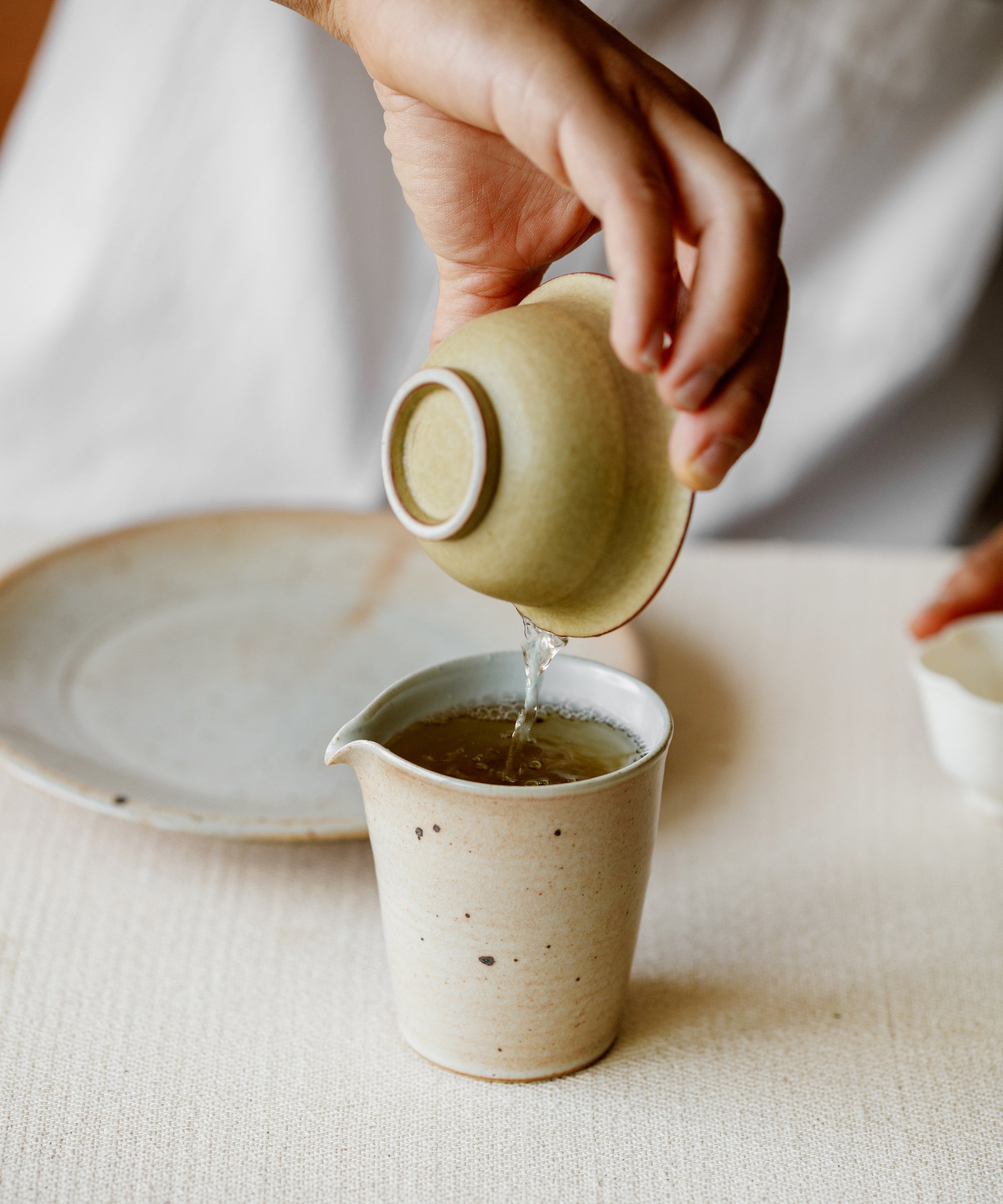 Silver Needle & Tea Blossoms infusing in hot water with floating tea blossoms