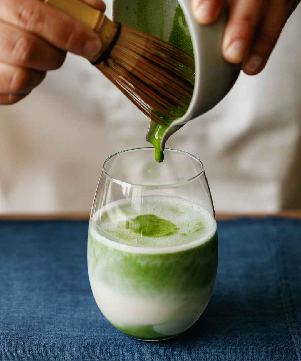 Pouring Matcha Yamabuki latte from pitcher into glass
