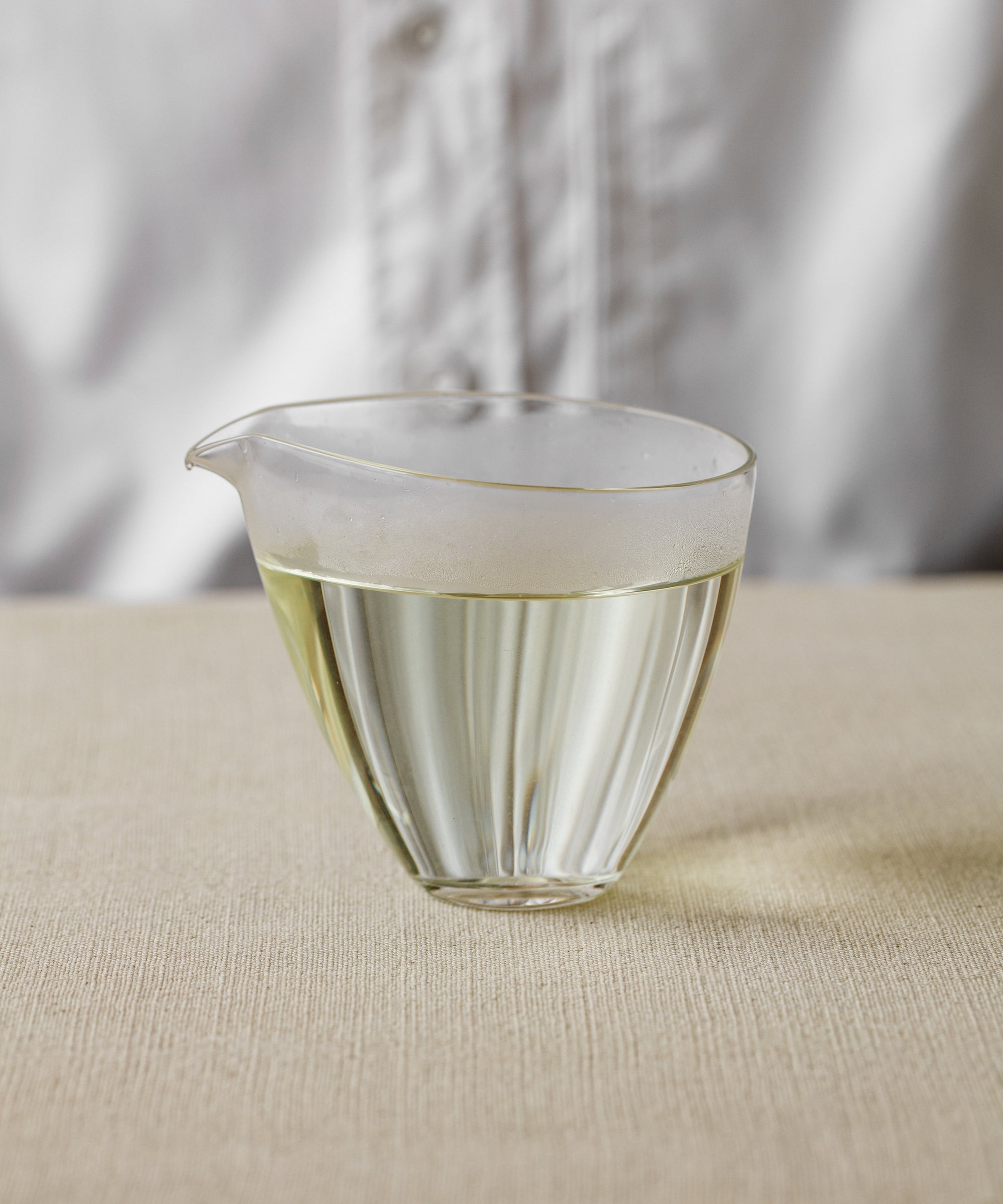 Pouring brewed Anji Baicha into a small cup