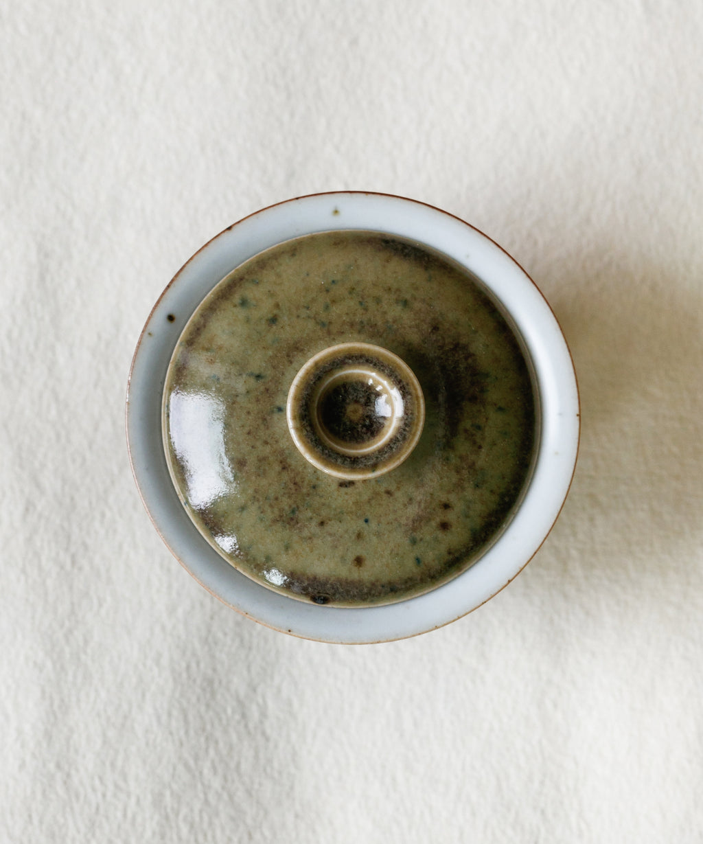 Mini Purple Rain Gaiwan in hand, purple rain glaze showing scale, Wang Xinghua gongfu teaware