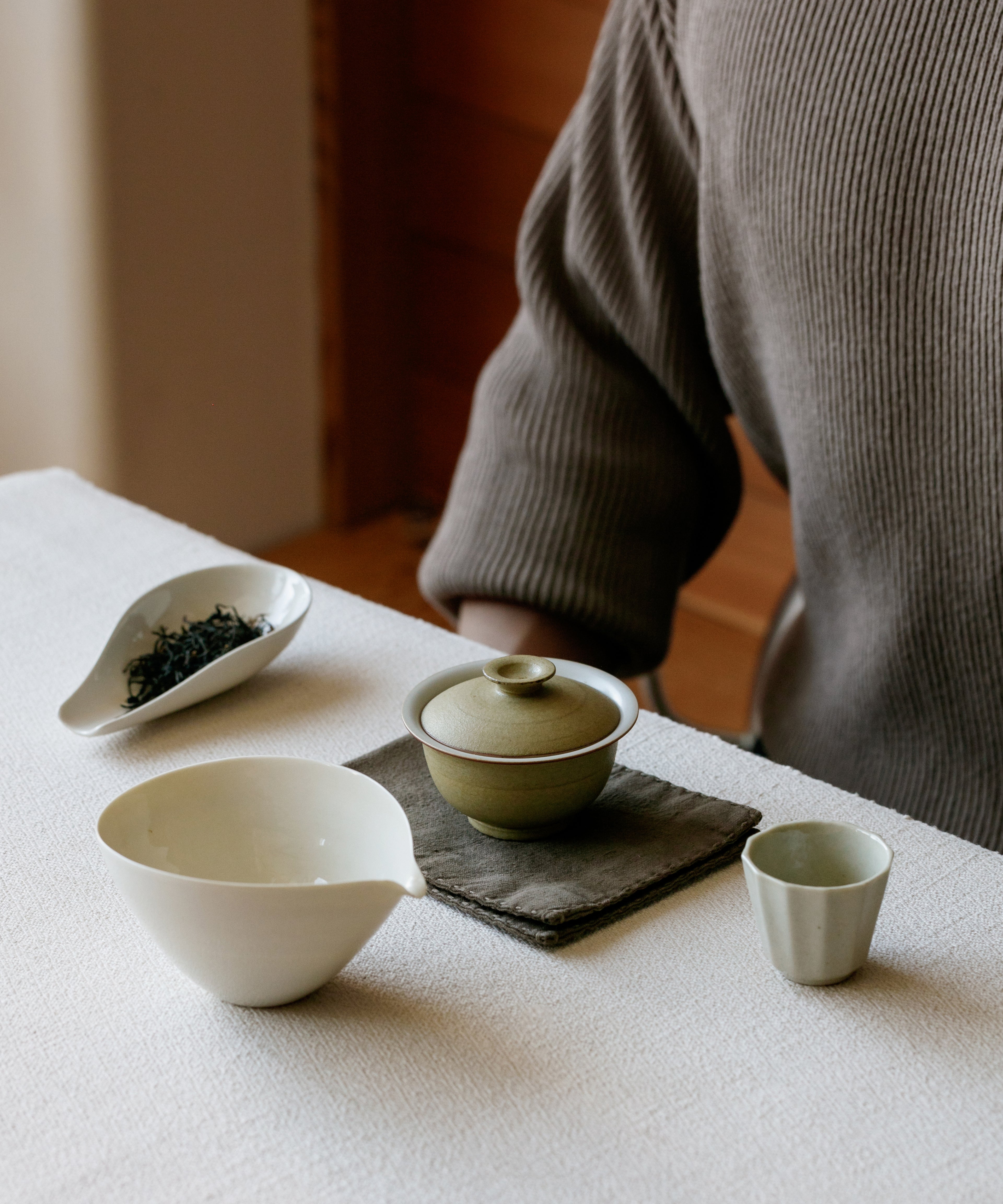 Mini Matte Yellow II Gaiwan in hand, matte yellow glaze showing scale, Wang Xinghua gongfu teaware