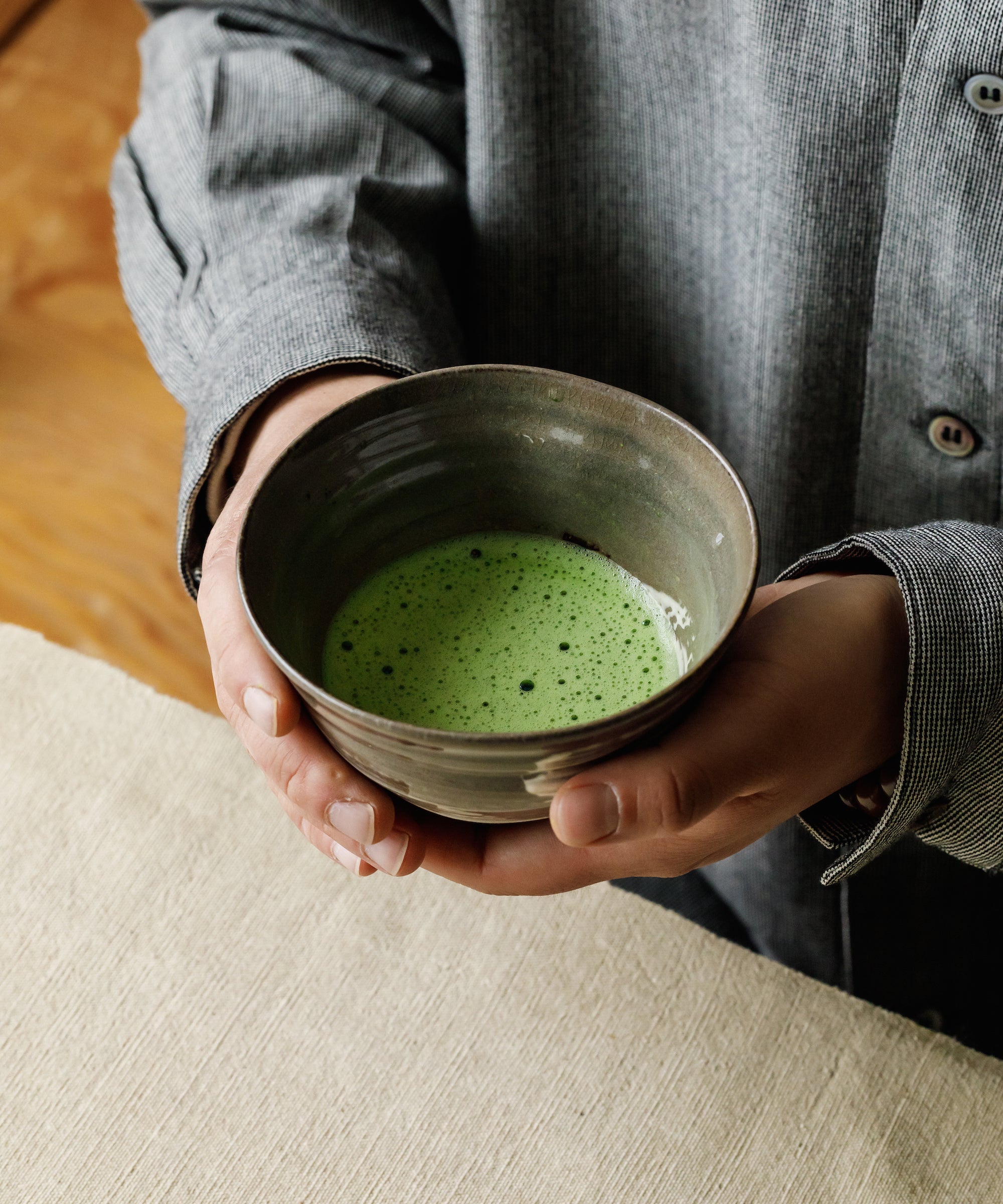 Whisked Matcha Hatsumukashi in bowl — smooth milk-coating mouthfeel, charcoal finished by Arita Sansuien