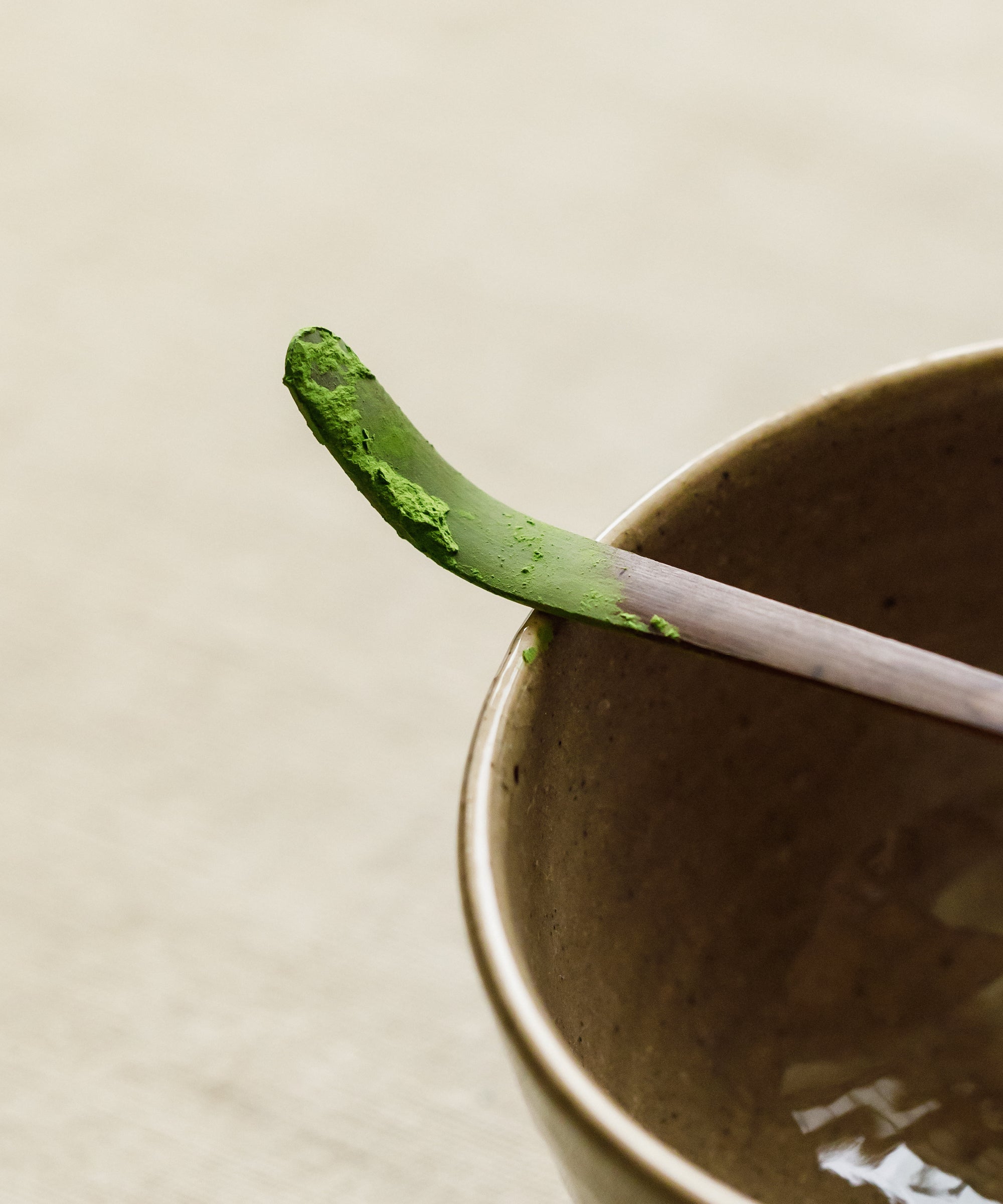 Detail of Mare matcha powder showing stone-ground texture, charcoal-finished with kishu binchotan