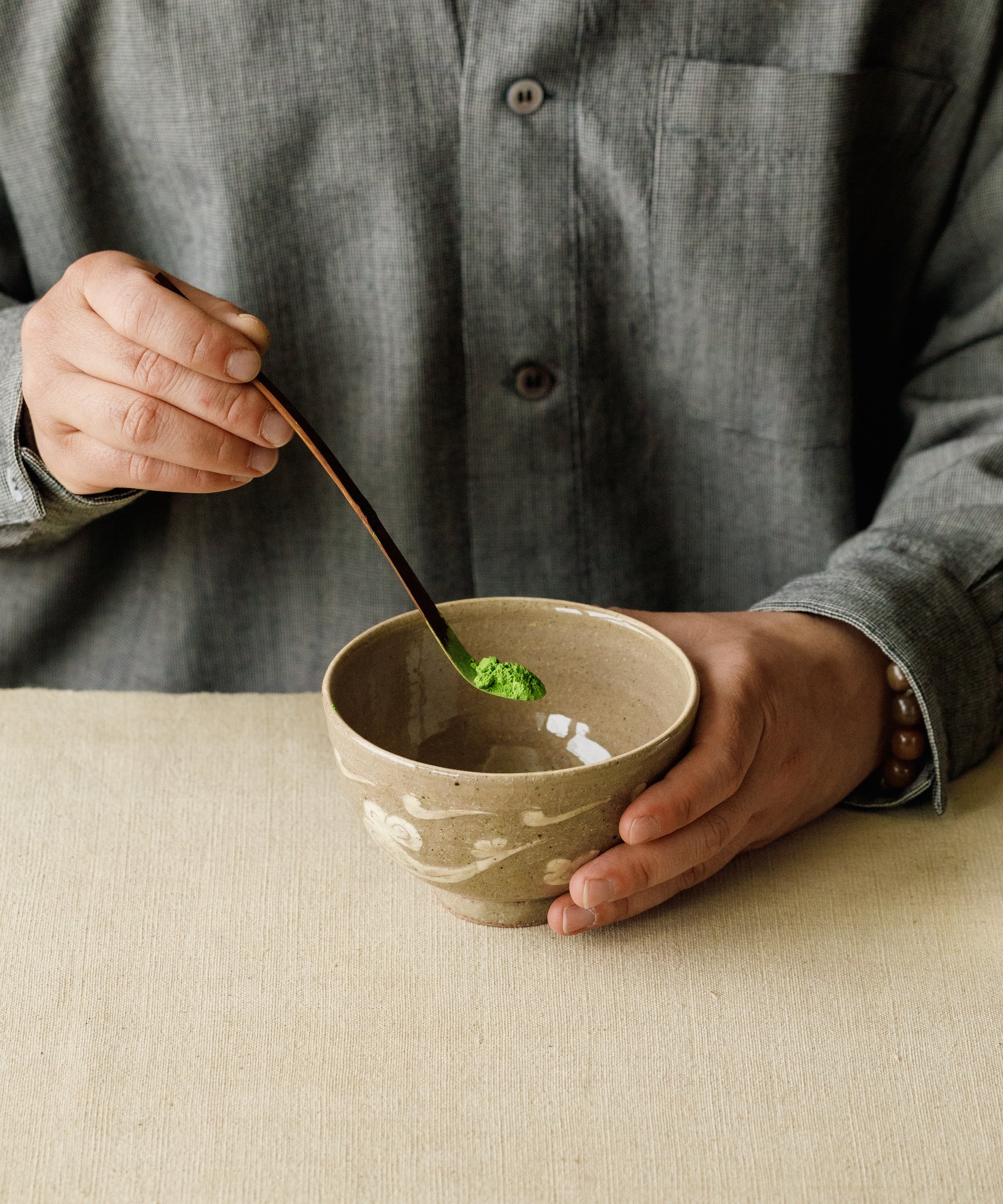 Whisking Mare matcha with a bamboo chasen in a traditional chawan