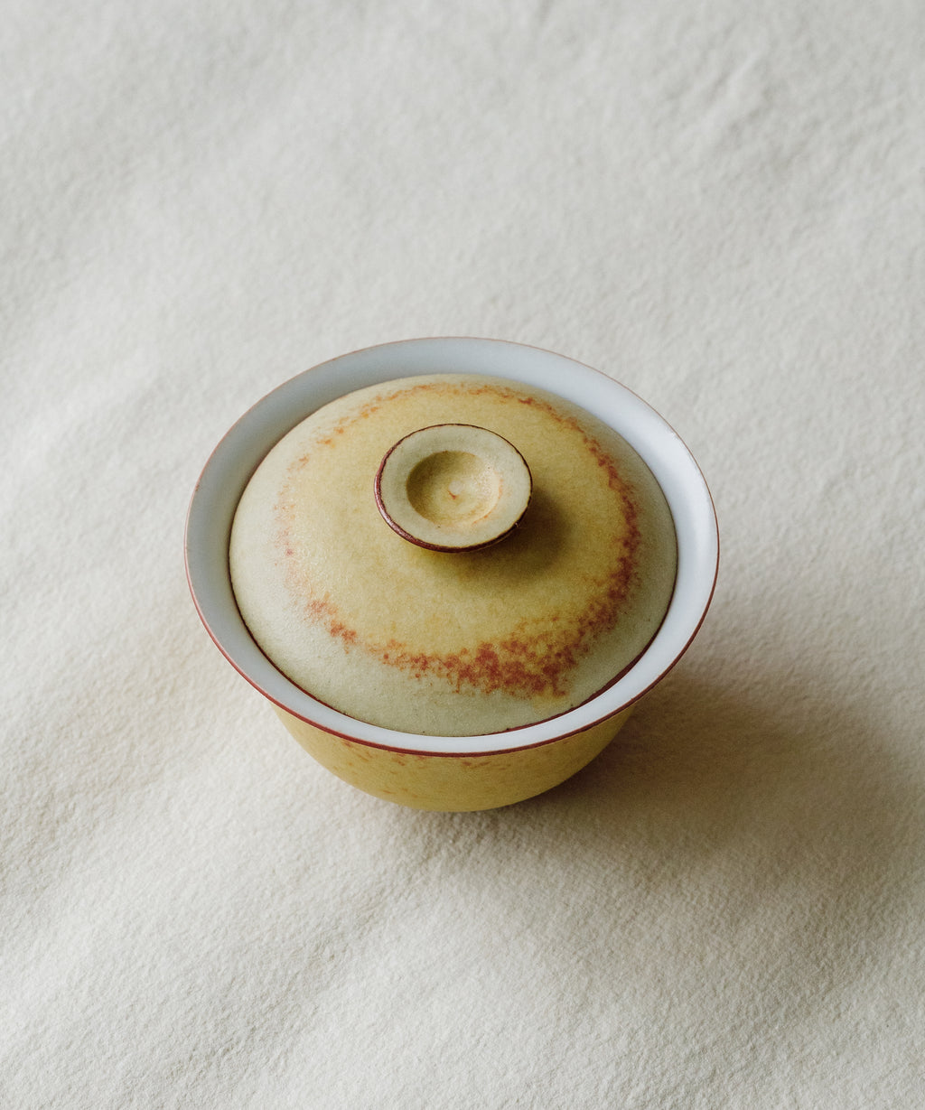 Mini Fire Yellow Gaiwan in hand, fire yellow glaze showing scale, Wang Xinghua gongfu teaware