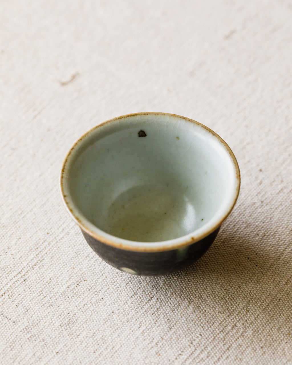 Cup Black Peacock glaze detail, peacock-feather markings, Jingdezhen clay and porcelain