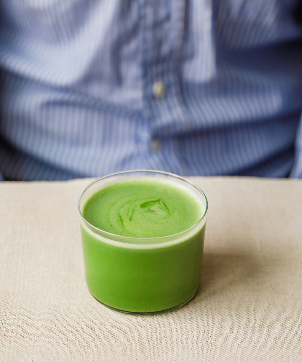 Preparing Oku Yutaka matcha latte by whisking in a clear glass with milk