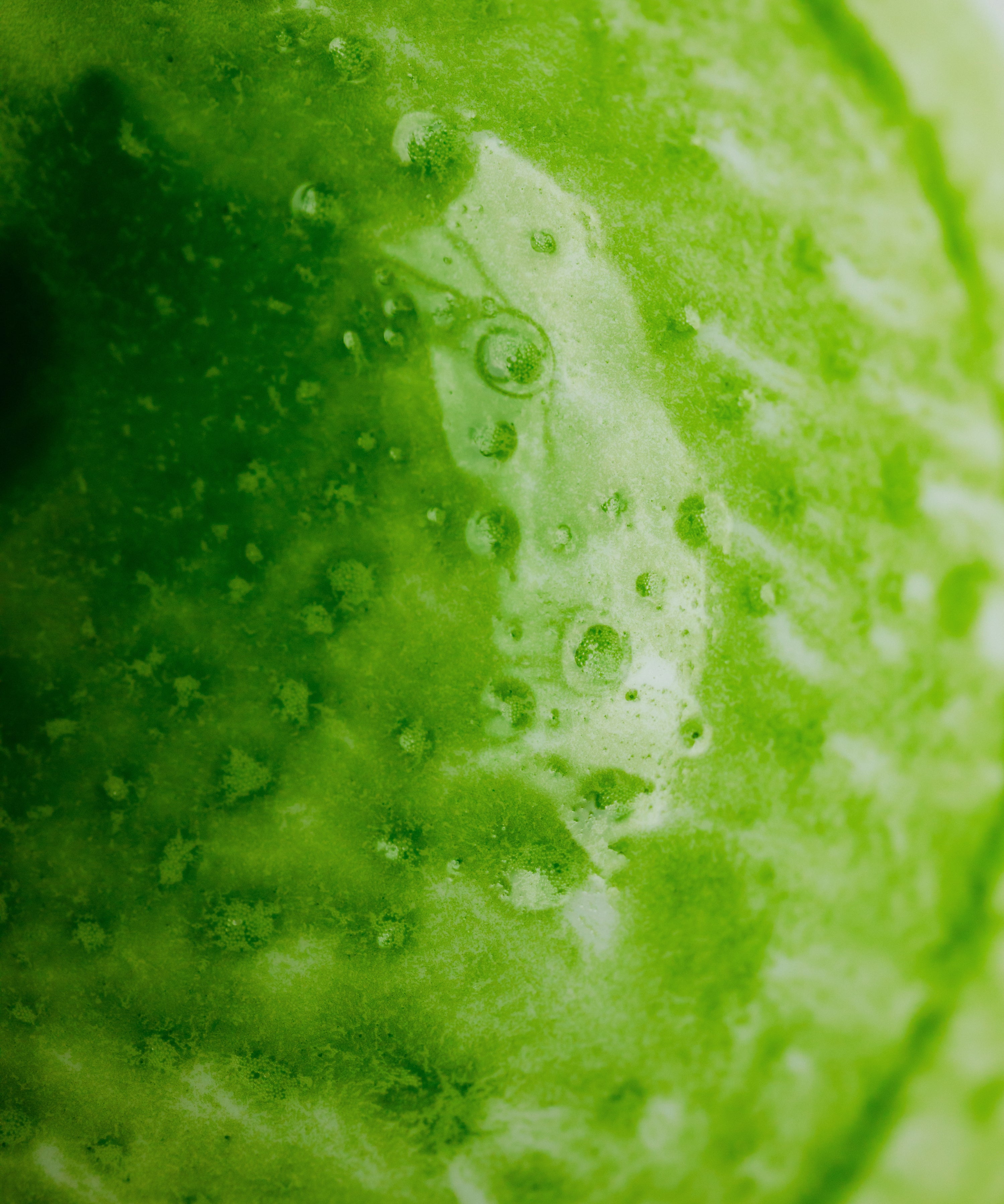 Preparing Ooiwase matcha latte by whisking in a clear glass