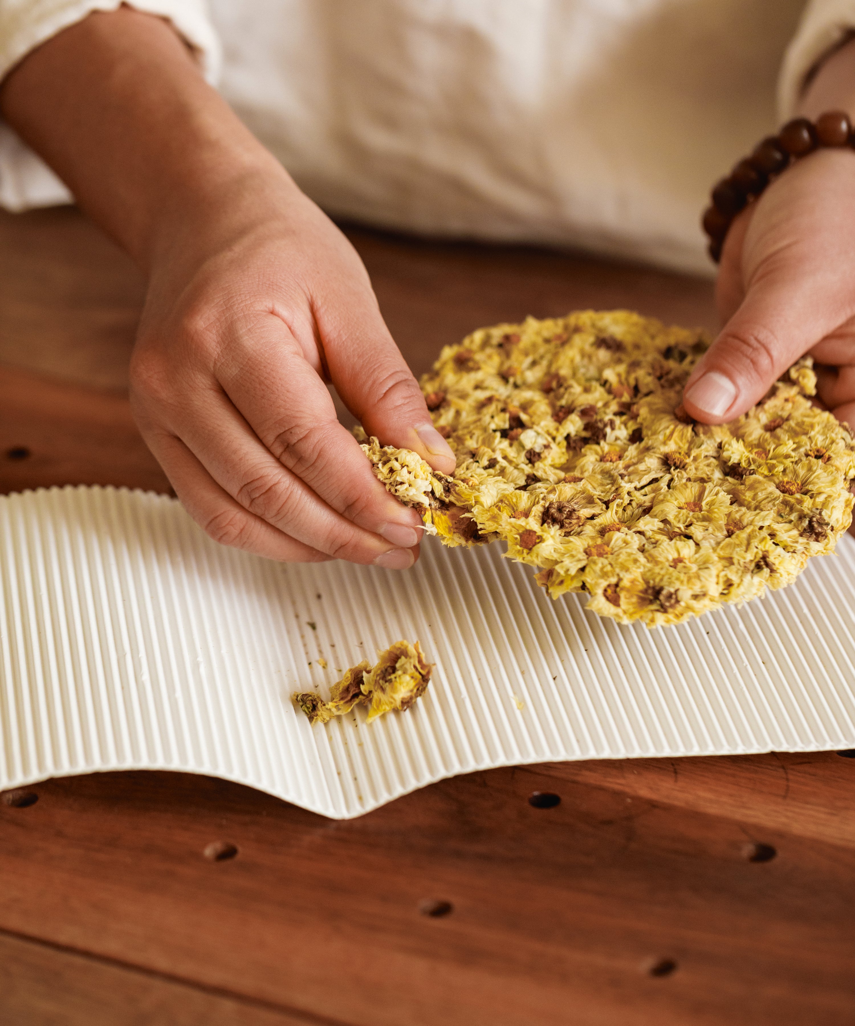 Silk Chrysanthemum Cake pressed flowers, traditionally steamed over camphor wood fire, Tongxiang, Zhejiang