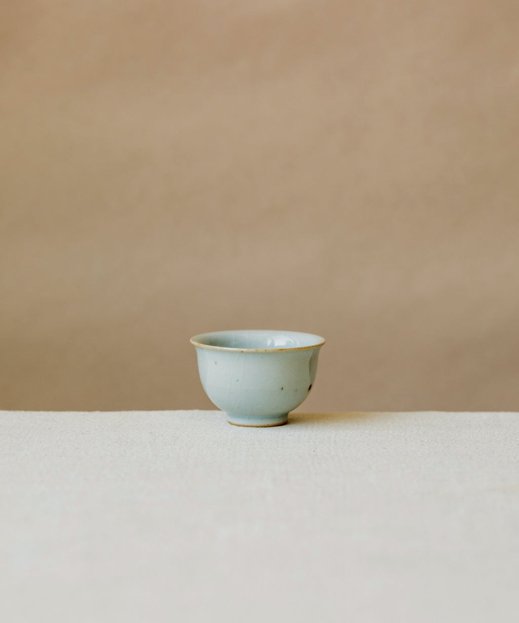 Cup Celadon Ice, handcrafted tea cup by Wang Xinghua, Jingdezhen, slick frozen-lake glaze with crackle veins