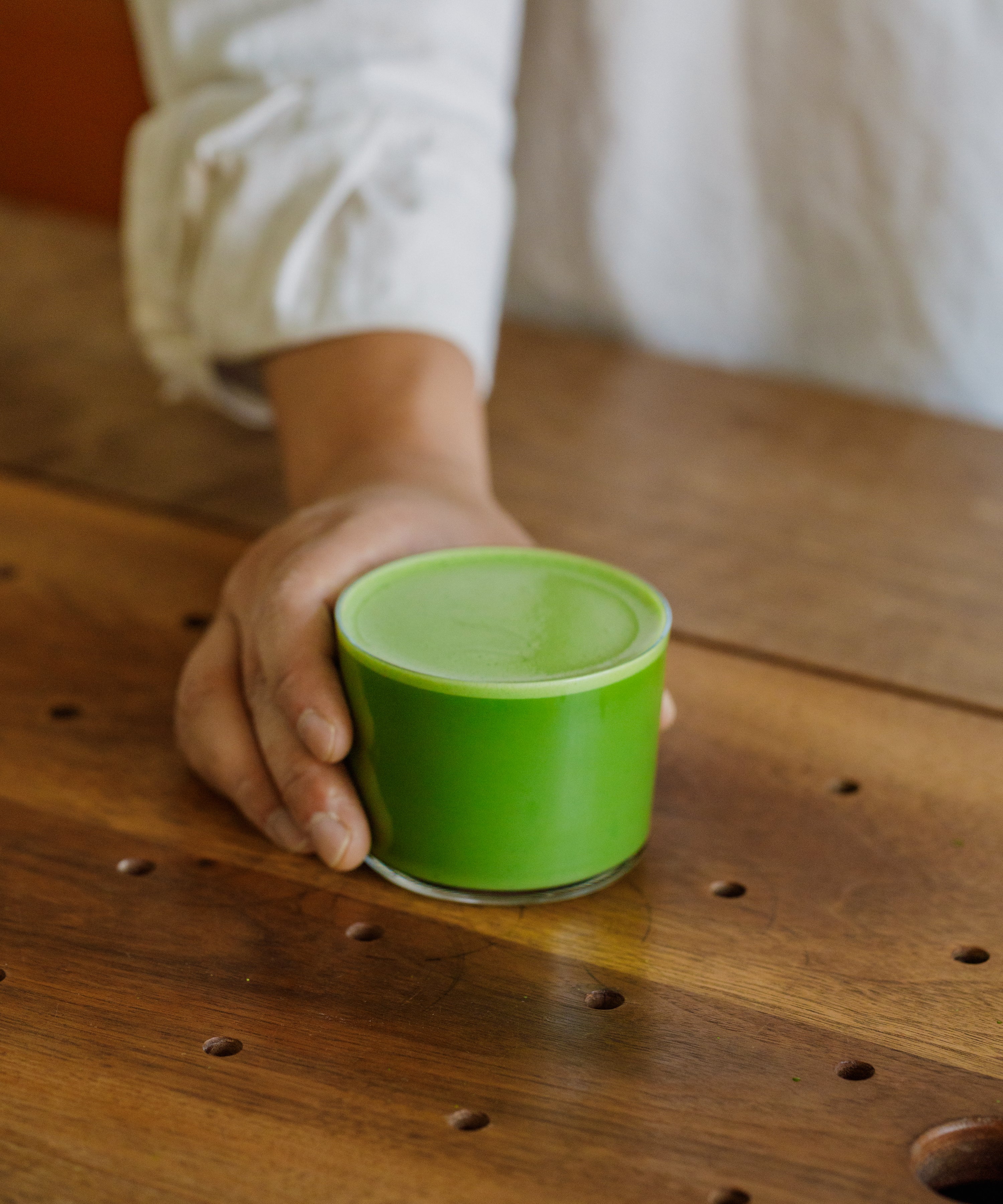 Holding a small cup of Saemidori matcha at the Cultivate Tea cafe
