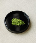 Matcha Hikari premium Japanese latte grade matcha powder in black ceramic bowl