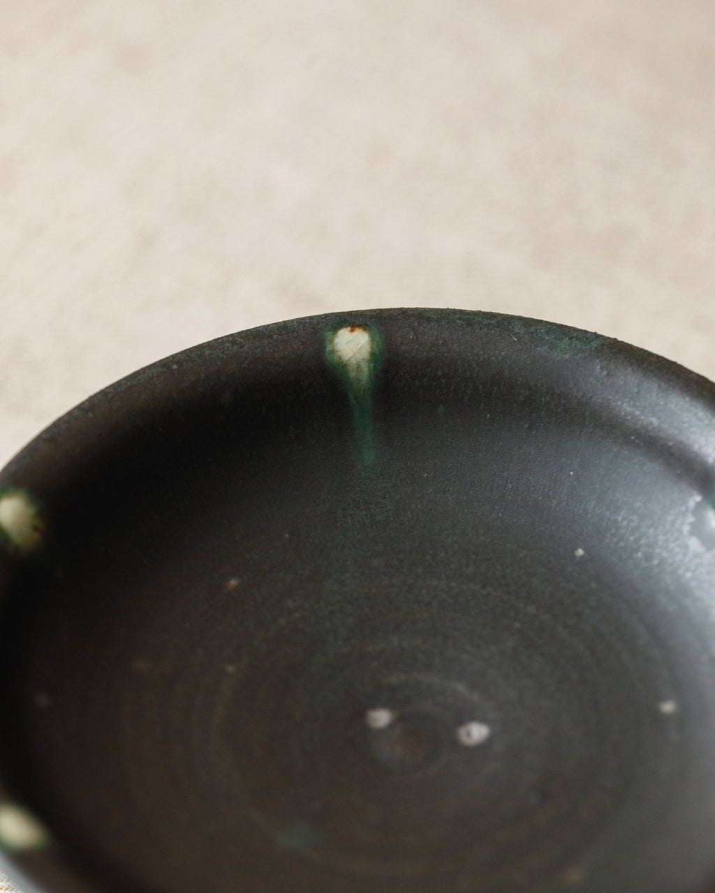 Pedestal Plate Black Peacock side view, raised pedestal form, handcrafted by Wang Xinghua, Jingdezhen