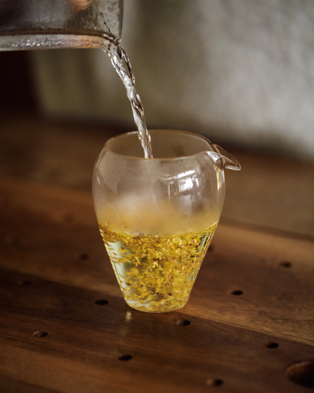 Gold Osmanthus flowers in a white preparation vessel