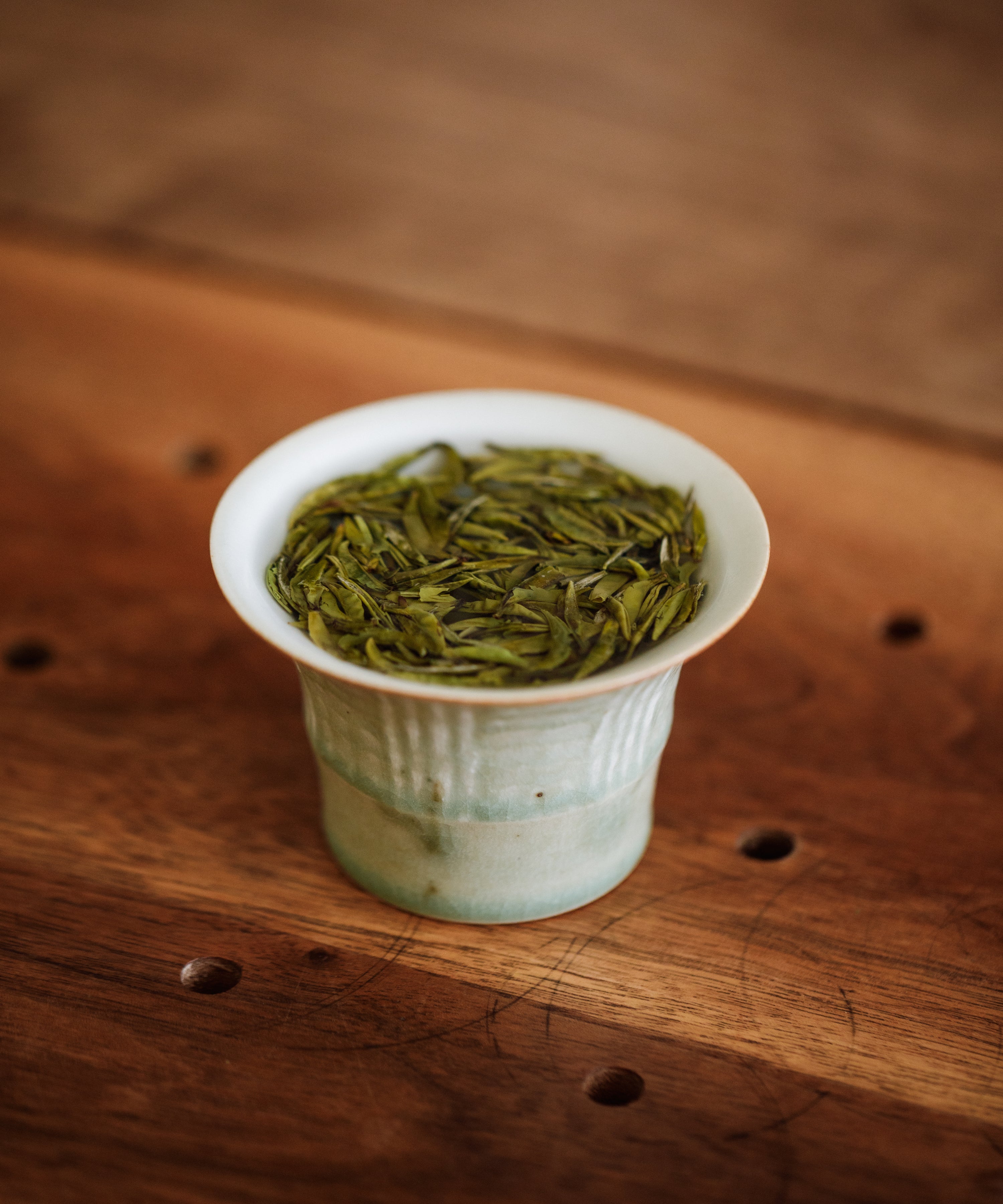 Brewing Gardenia Bird's Tongue — hot water over gardenia-scented green tea buds in glass vessel