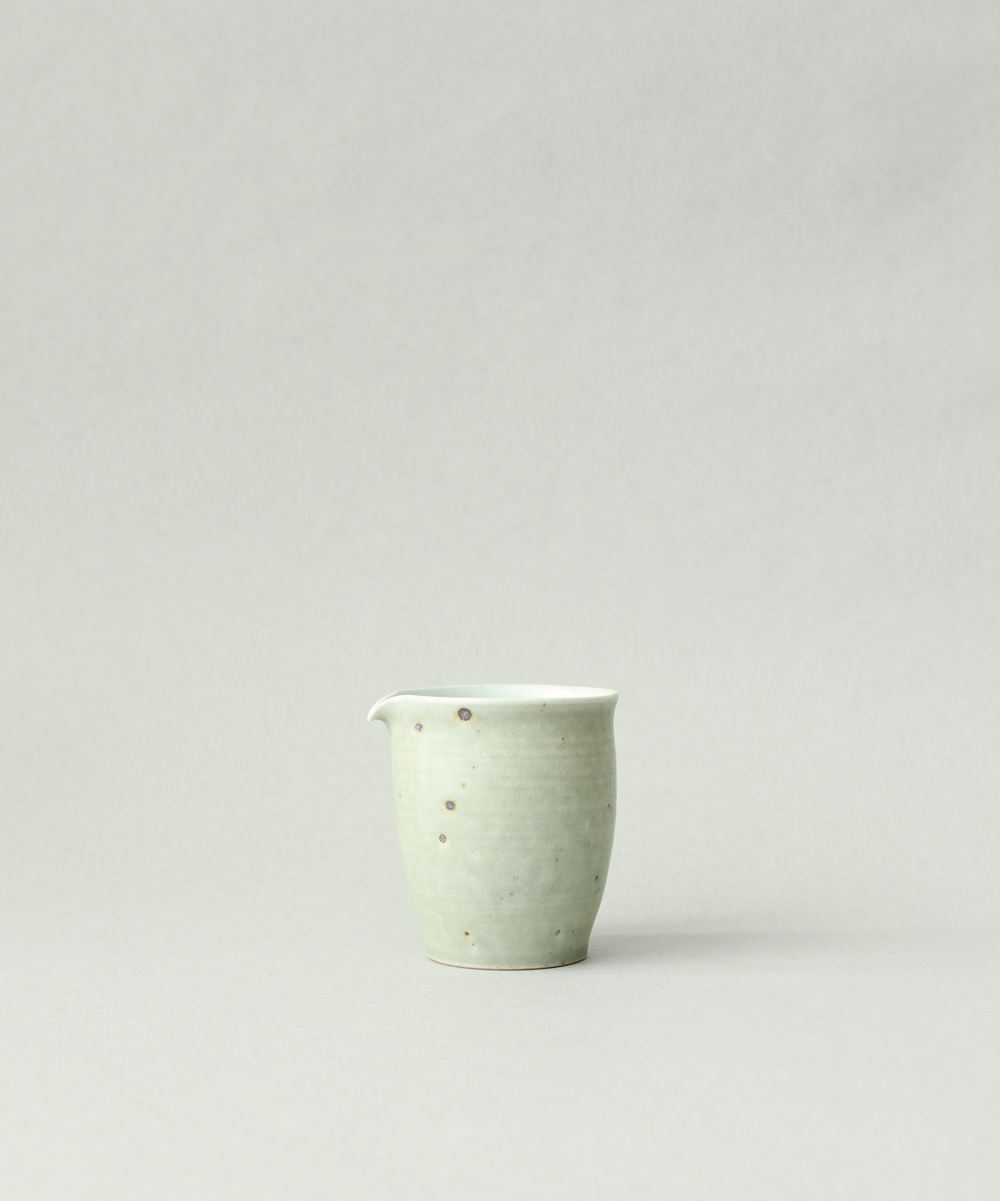 Green Celadon Pitcher Type IV, handcrafted tea pitcher by Wang Xinghua, Jingdezhen, matte green celadon with iron freckles