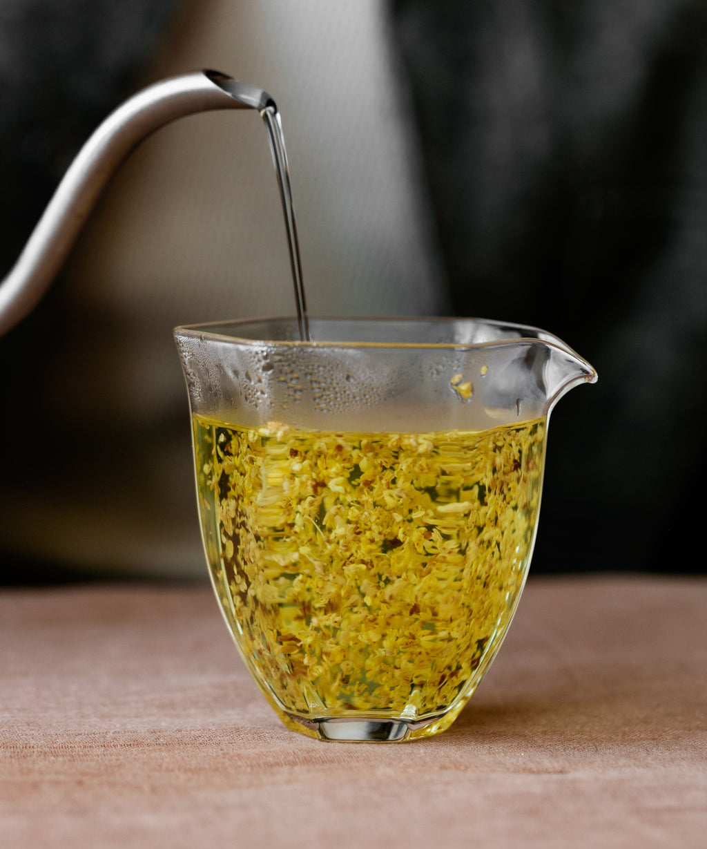 Cup of brewed Gold Osmanthus showing pale golden liquor with mango-like fruity notes