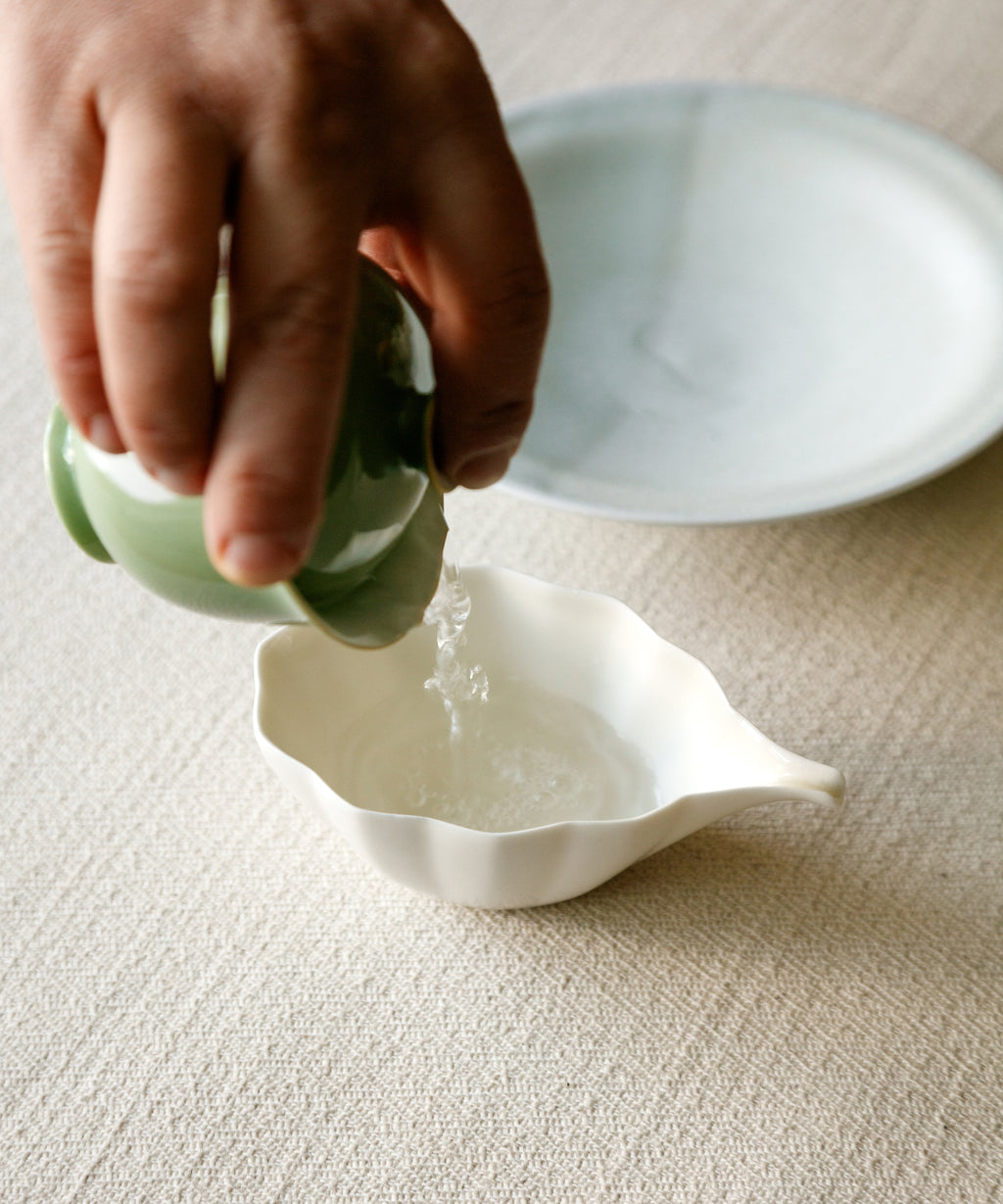 Pouring Jasmine Jade Tips from pitcher — milky, enveloping jasmine with deep warmth