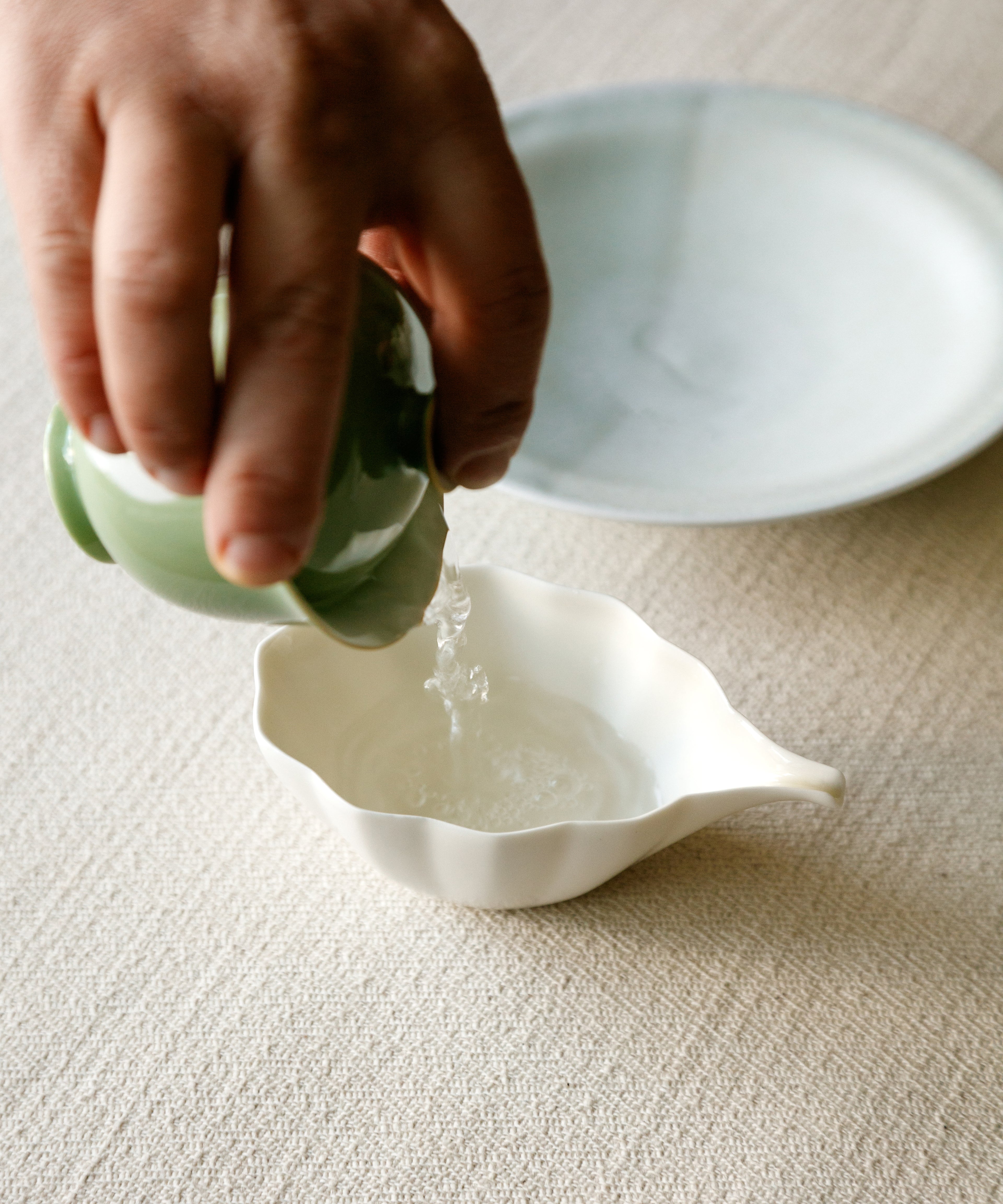 Pouring Jasmine Jade Tips from pitcher — milky, enveloping jasmine with deep warmth
