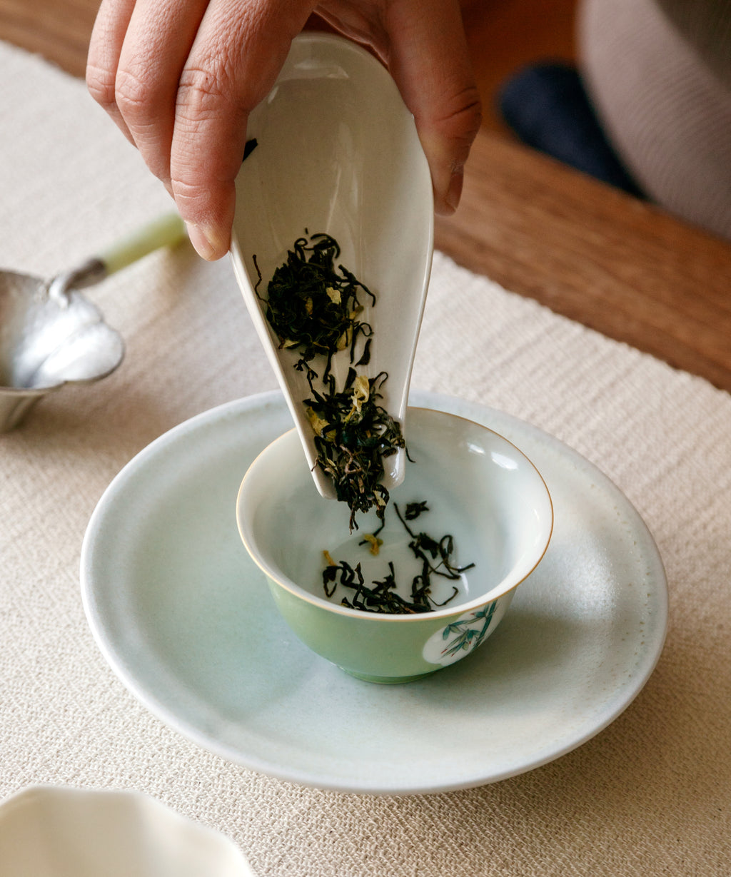 Jasmine Jade Tips dry leaves with flowers on dish — jasmine-scented Maofeng green tea, Ya'an, Sichuan