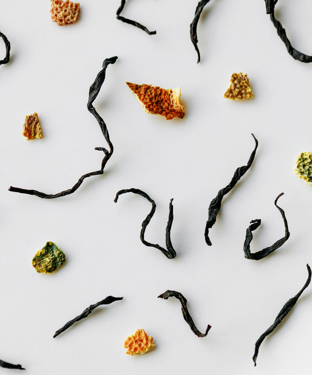 Wet Yuzu & Gold Guanyin leaves after brewing showing the rolled black tea form