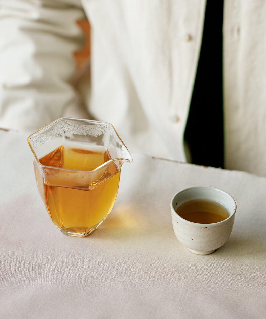 Brewed Yuzu & Gold Guanyin poured from gaiwan into a tea cup